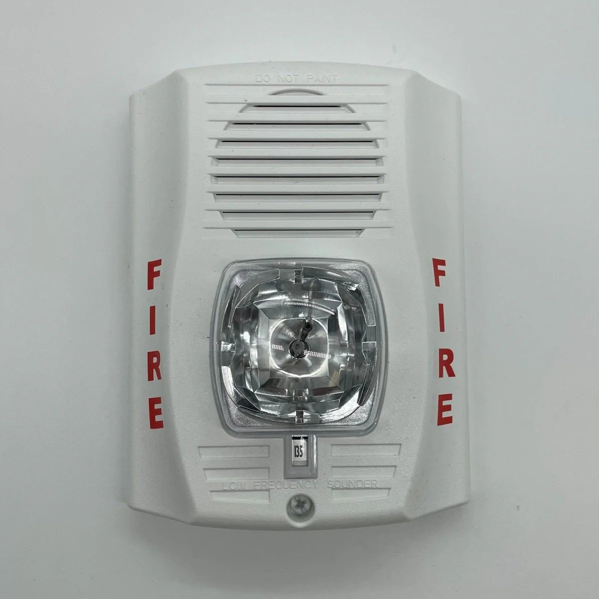System Sensor P2WH-LF smoke detector with white plastic cover, mounted on ceiling for fire detection safety.