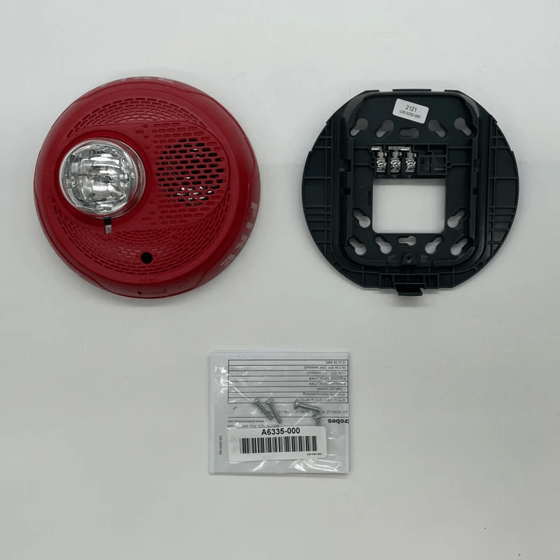 System Sensor PC2RL-LF fire alarm control panel with LCD display and control buttons, mounted on a wall.