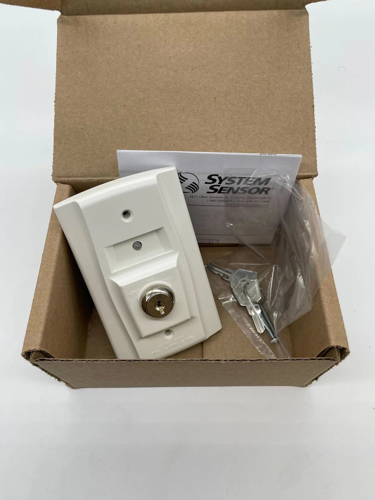 System Sensor RTS151KEY wireless key fob with buttons, designed for security system control, shown in image.