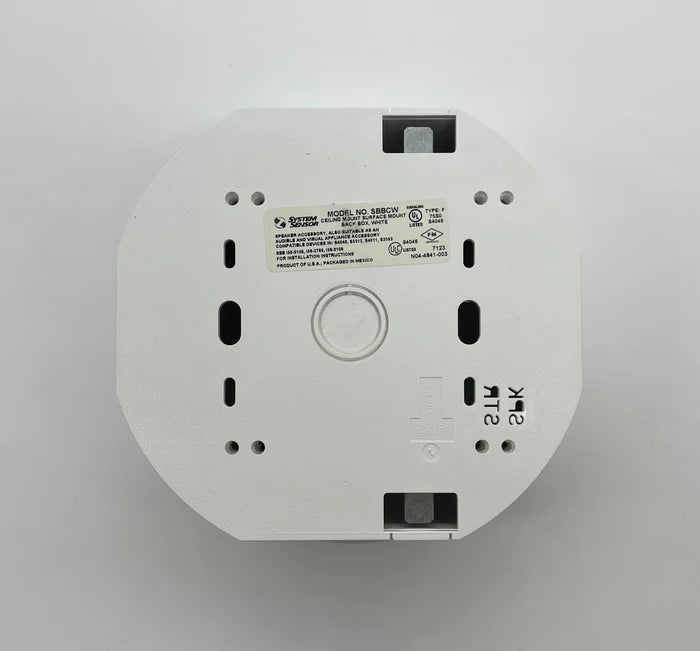 System Sensor SBBCW fire alarm control module with wiring and connectors, designed for building safety systems.
