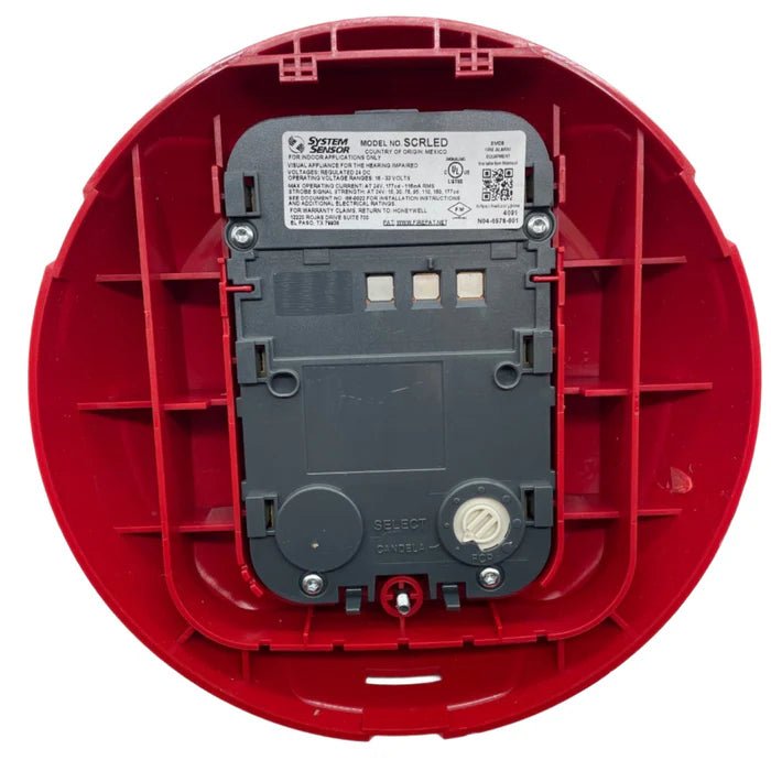 System Sensor SCRLED LED emergency lighting fixture with clear lens and mounting hardware for commercial safety applications.