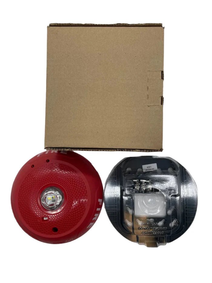 System Sensor SCRLED emergency LED exit sign with red lettering, mounted on a white background, for fire safety and signaling.