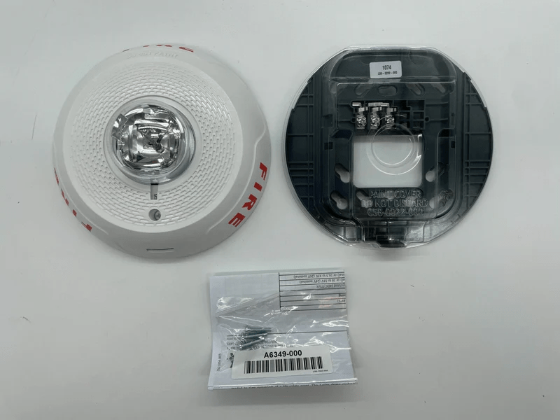 System Sensor SCWL wireless smoke detector with alarm and mounting base, designed for fire safety in commercial or residential settings.