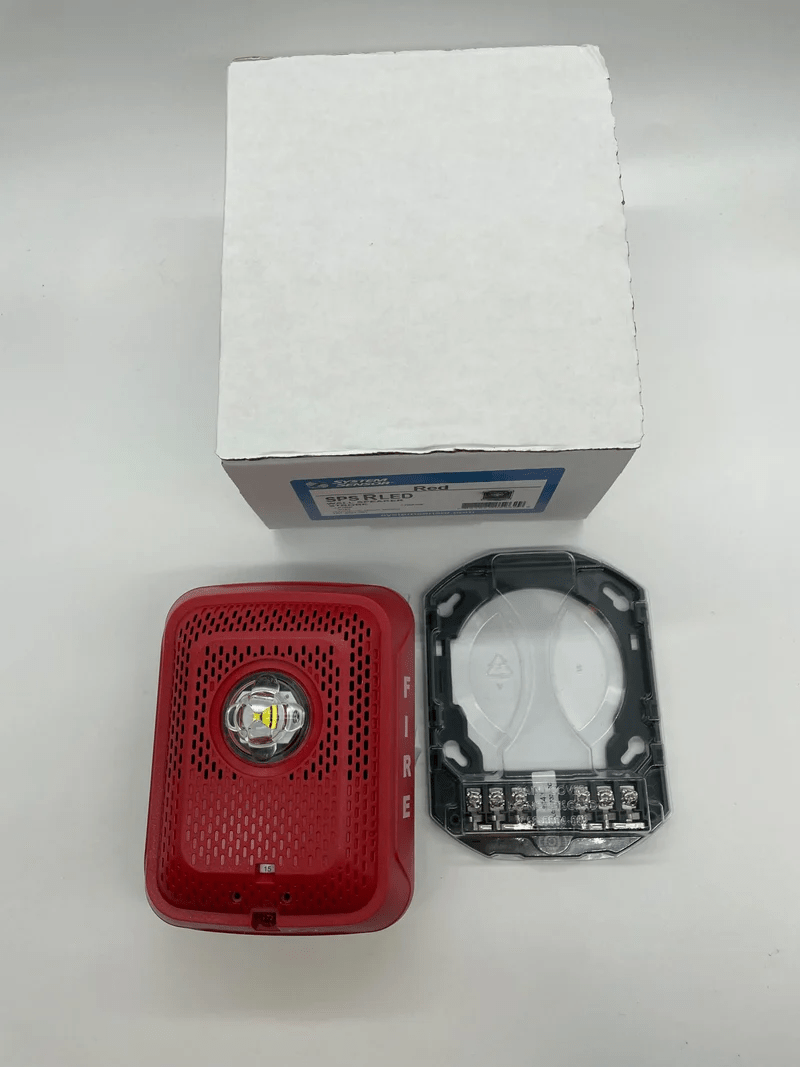 System Sensor SPSRLED emergency LED strobe light with red housing and mounting bracket for fire alarm systems.