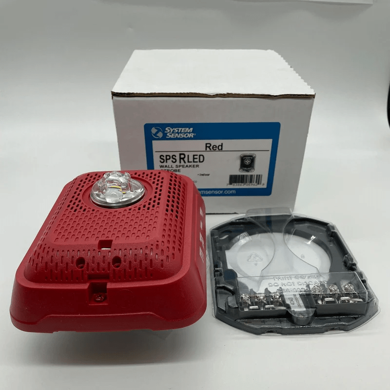 System Sensor SPSRLED emergency LED strobe light mounted on a ceiling for fire safety and alert signaling.