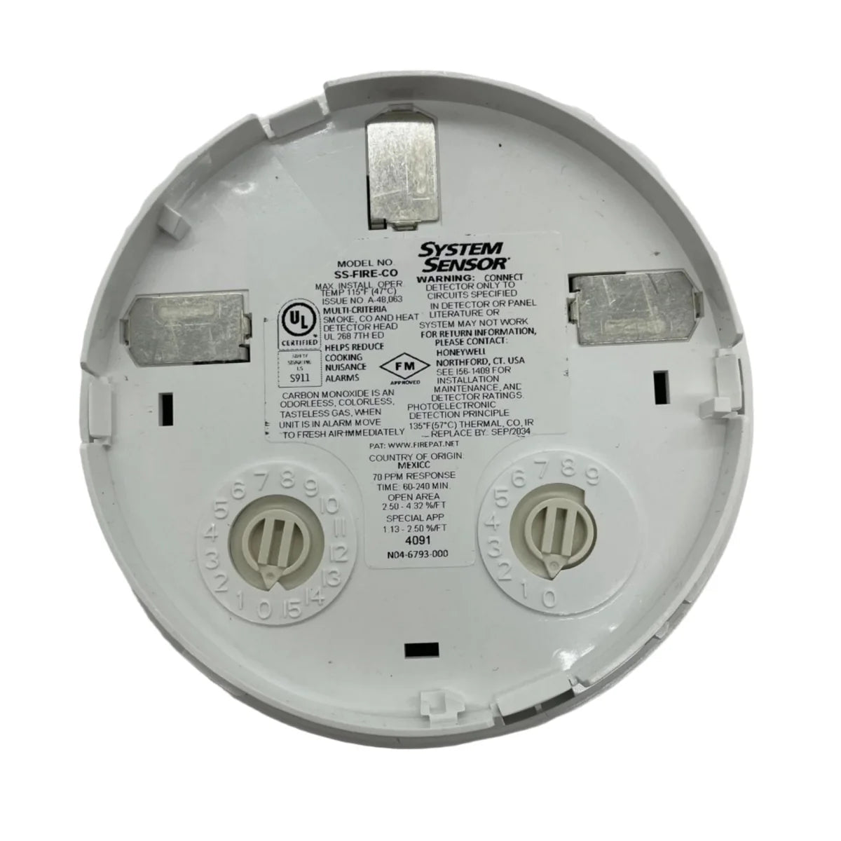 System Sensor SS-FIRE-CO fire alarm sensor with metal casing and wiring for smoke and carbon monoxide detection.