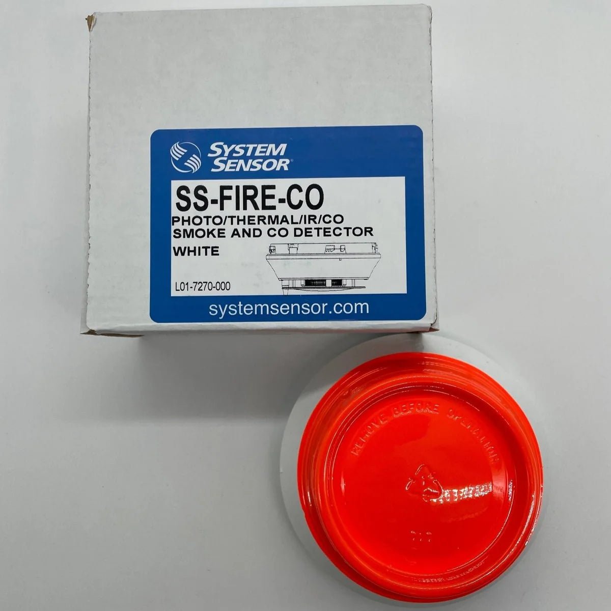 System Sensor SS-FIRE-CO fire and carbon monoxide alarm with digital display and test buttons, mounted on a wall.