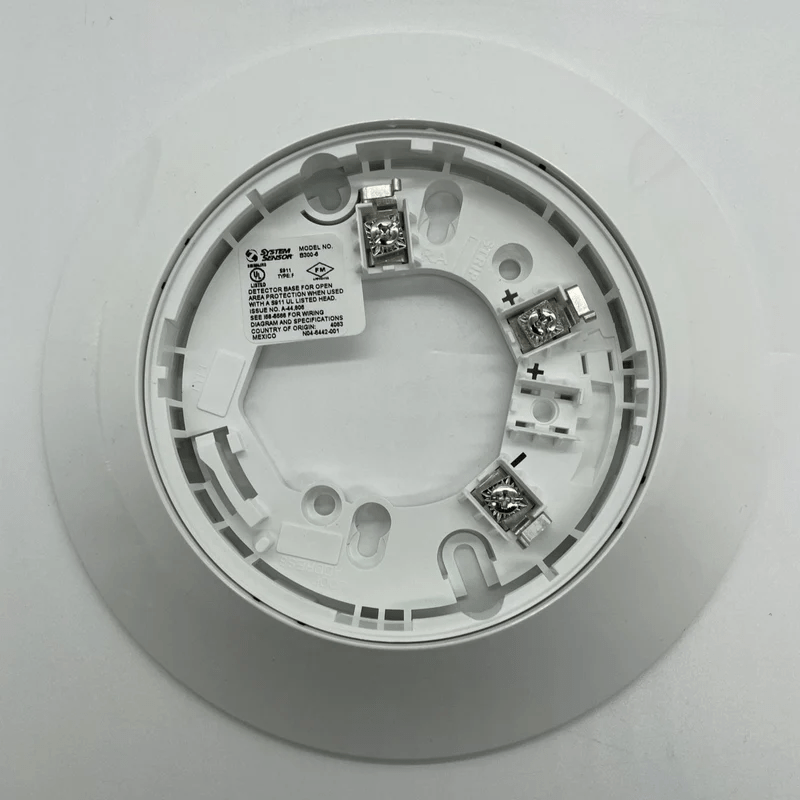 System Sensor SS-HEAT-ROR heat detector with reset feature, shown mounted on a ceiling in a professional setting.