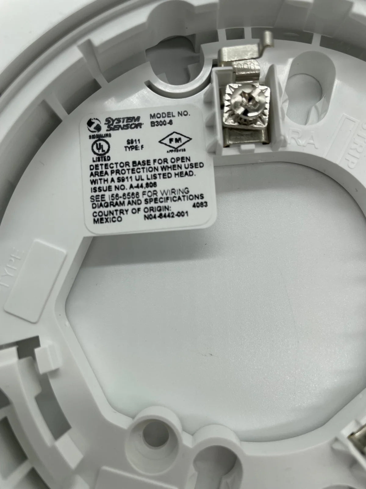 System Sensor SS-PHOTO photoelectric smoke detector with white plastic casing and mounting bracket.