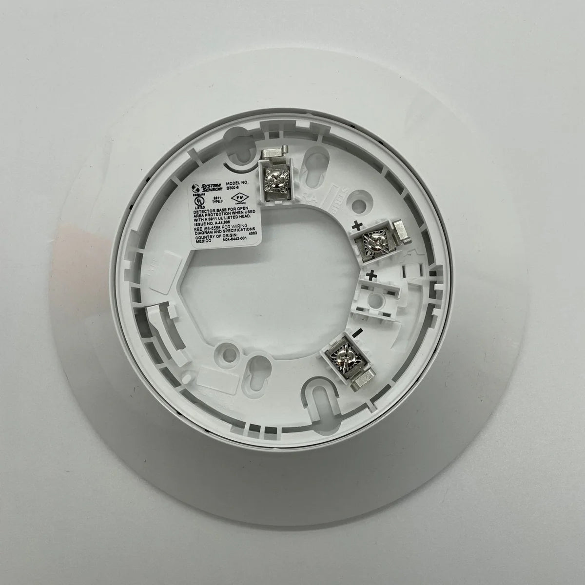 System Sensor SS-PHOTO photoelectric smoke detector with white plastic housing and mounting bracket.