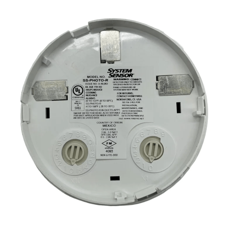 System Sensor SS-PHOTO-R photoelectric smoke detector with white plastic casing and mounting bracket.