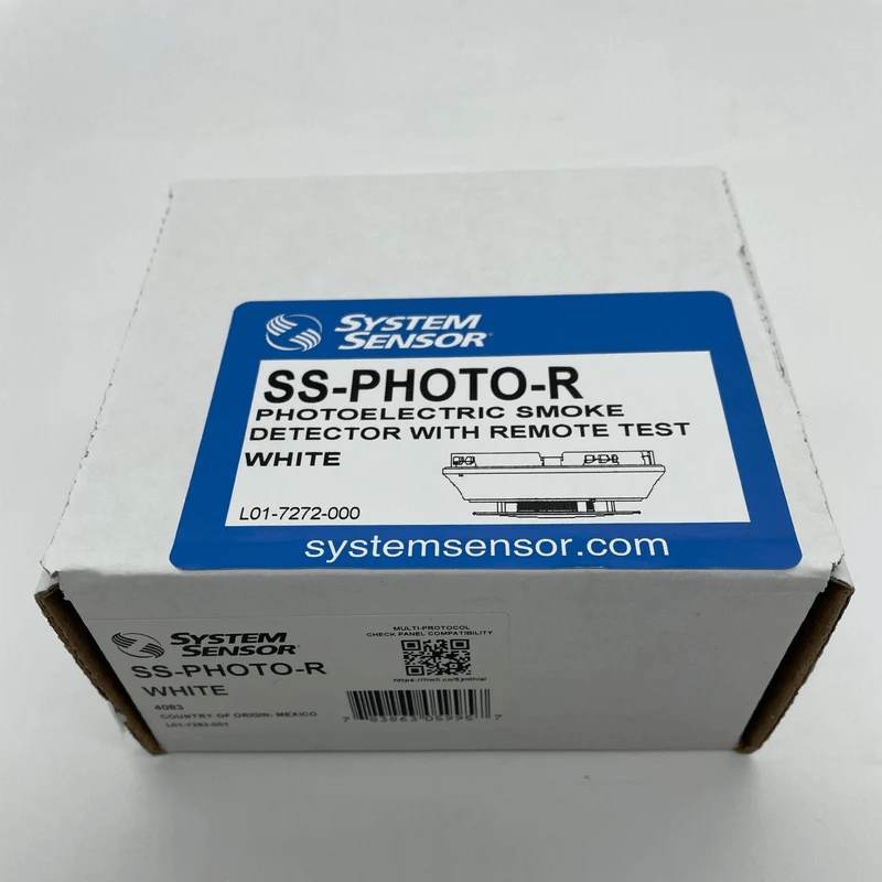 System Sensor SS-PHOTO-R photoelectric smoke detector with mounting bracket, mounted on ceiling in a commercial setting.