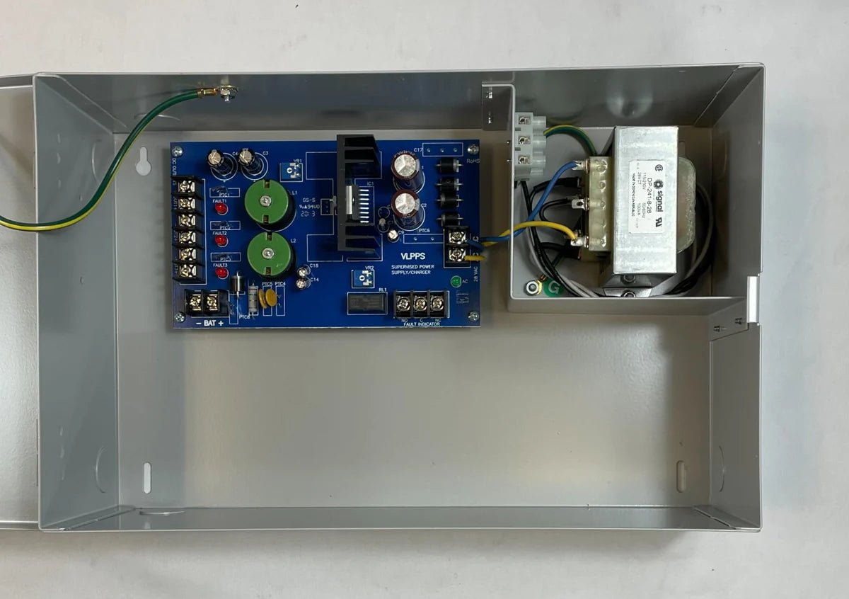 Vesda VPS-100US-220 fire alarm device from VESDA, mounted on wall, with control panel and wiring visible.
