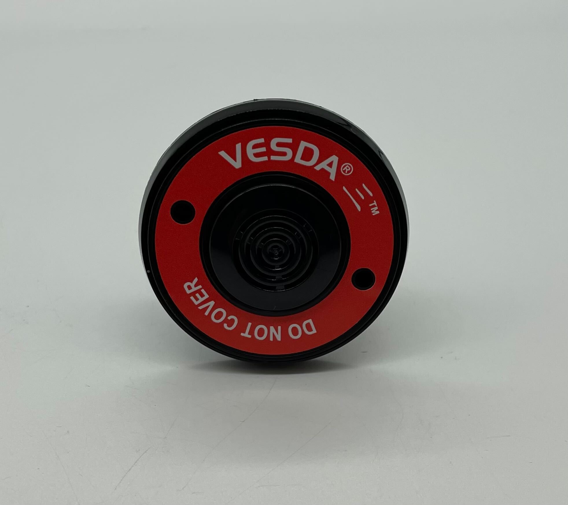 Vesda VSP-981-B22 fire alarm from VESDA, shown in a sleek black design with installation components on a white background.