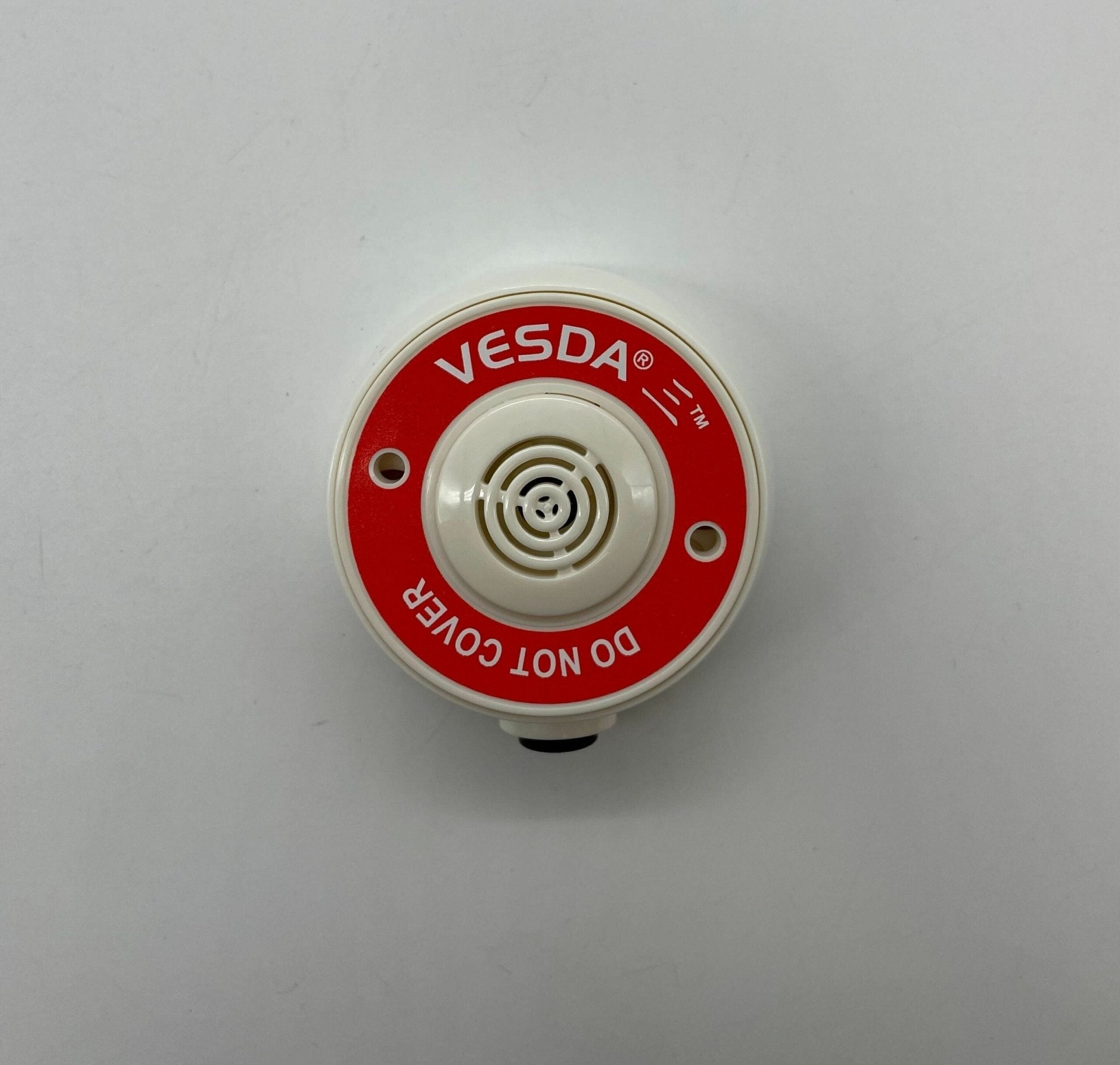 Vesda VSP-982-W sampling point, industrial fire detection component, mounted on a wall with piping and wiring visible