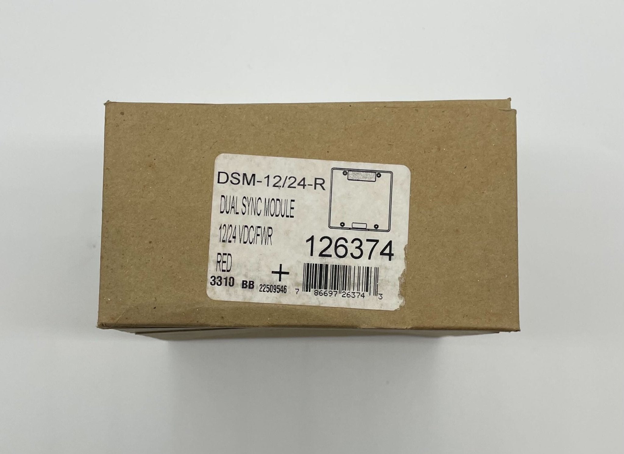Eaton Wheelock DSM-12/24-R sync module, compact device used for fire alarm systems, shown in close-up view.