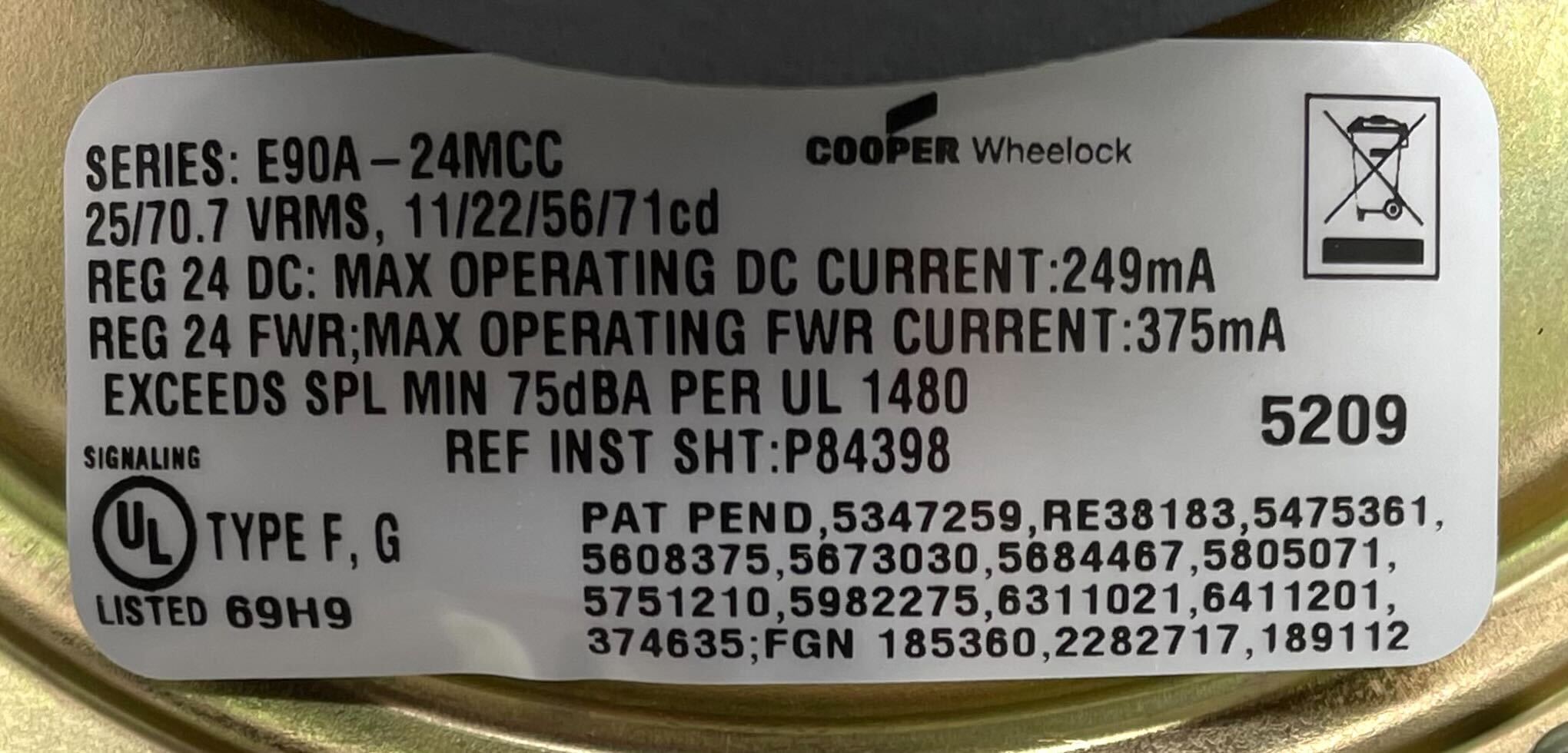 Eaton Wheelock E90A-24MCC-NW speaker strobe light mounted on ceiling, white color, for emergency signaling system.
