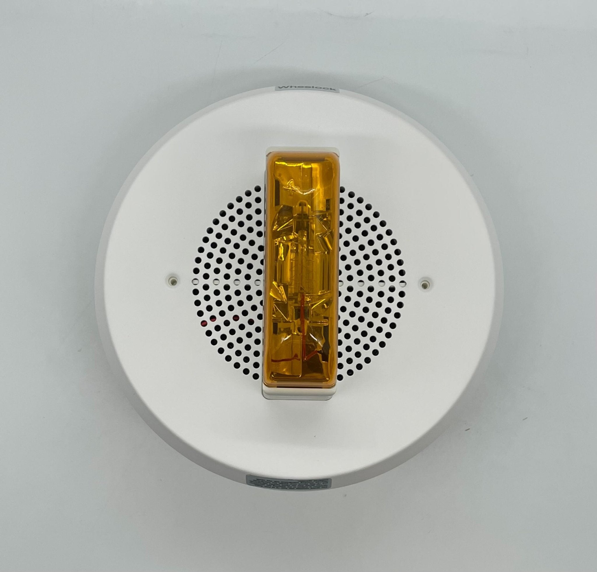 Eaton Wheelock E90A-24MCC-NW speaker strobe light mounted on ceiling, white color, for fire alarm signaling.