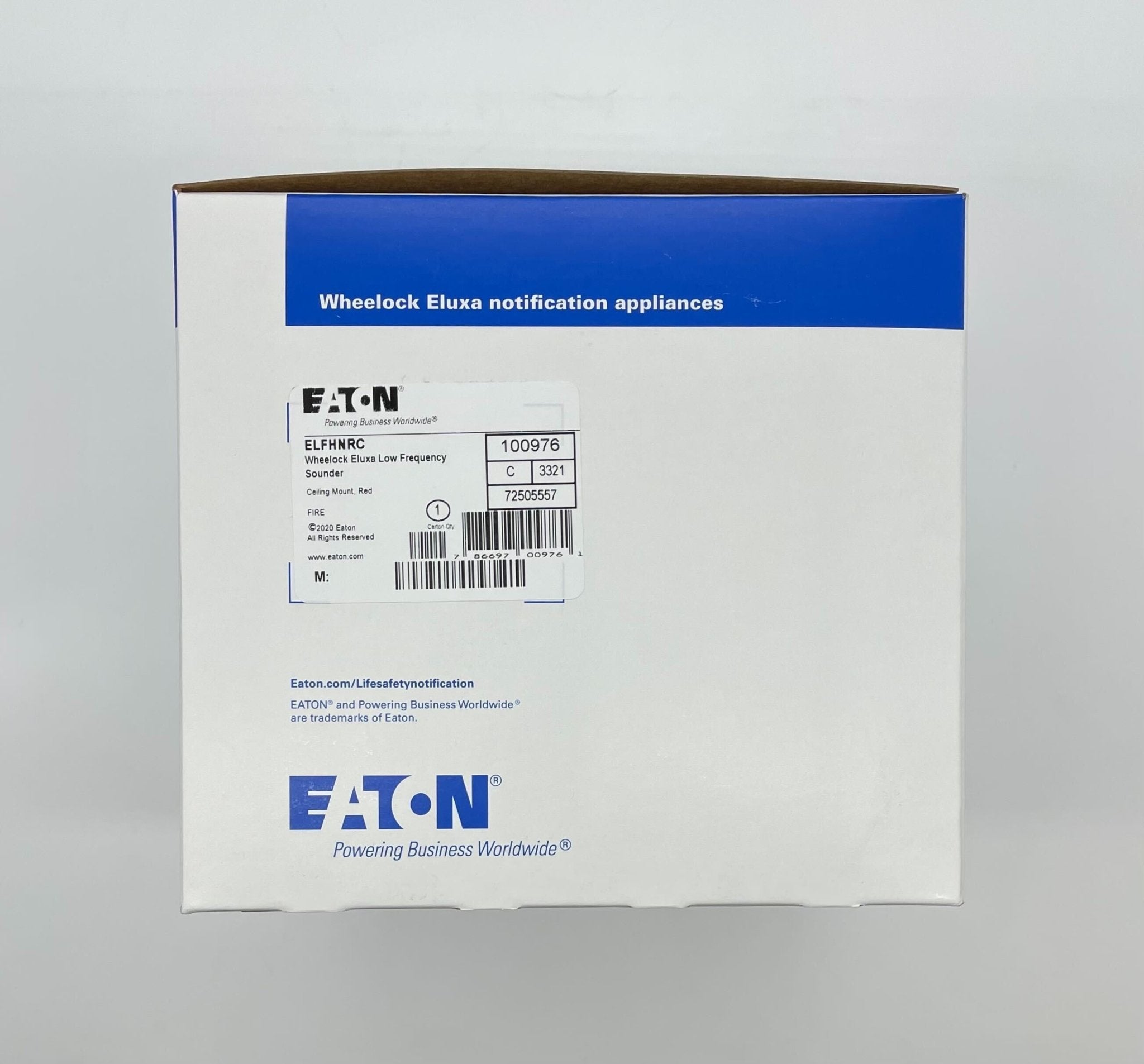 Eaton Wheelock ELFHNRC sounder mounted on a panel, showing industrial signaling device with wiring and mounting hardware.