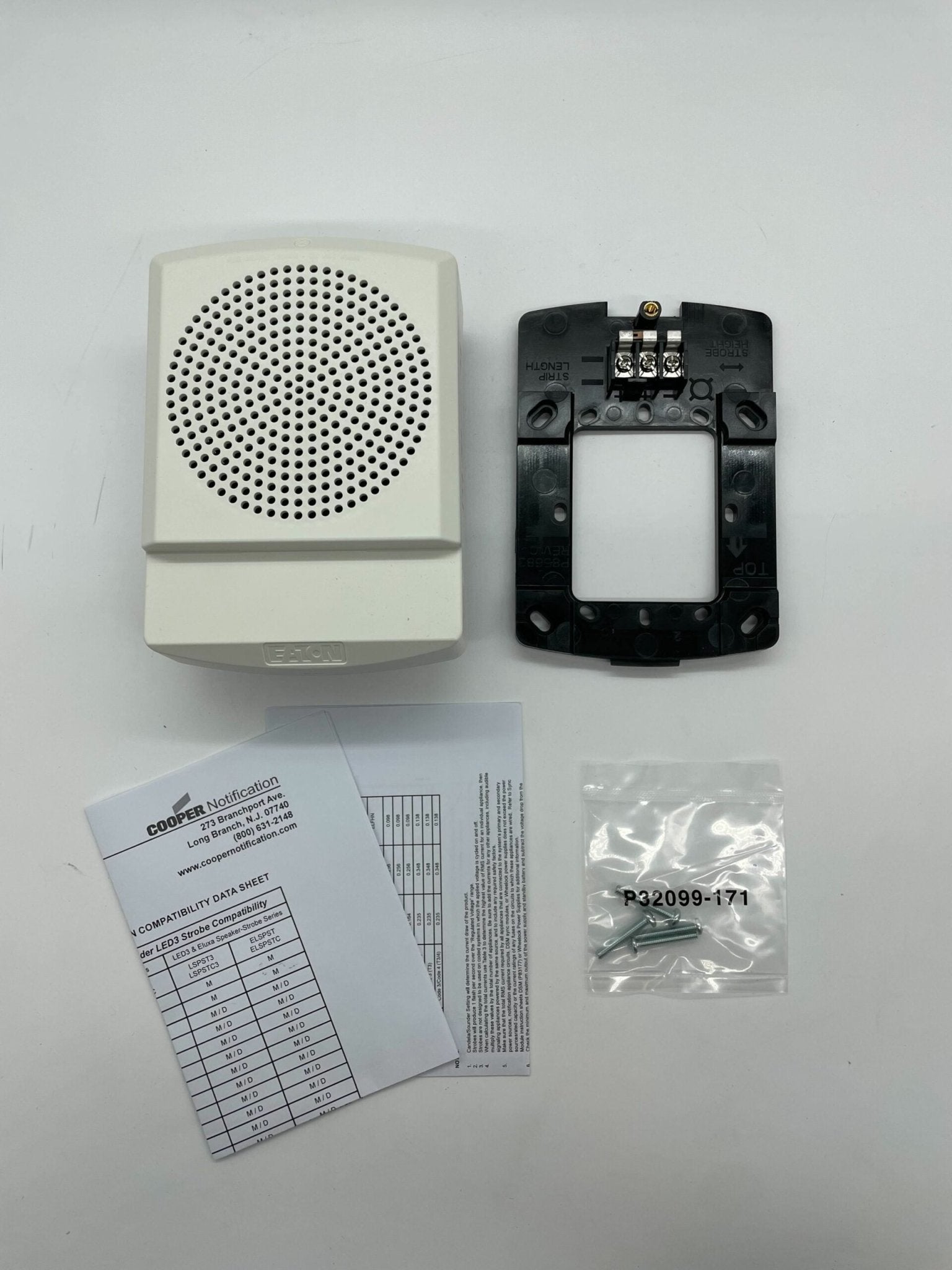 Eaton Wheelock ELFHNW sounder mounted on wall, black industrial alarm device with wiring connections.