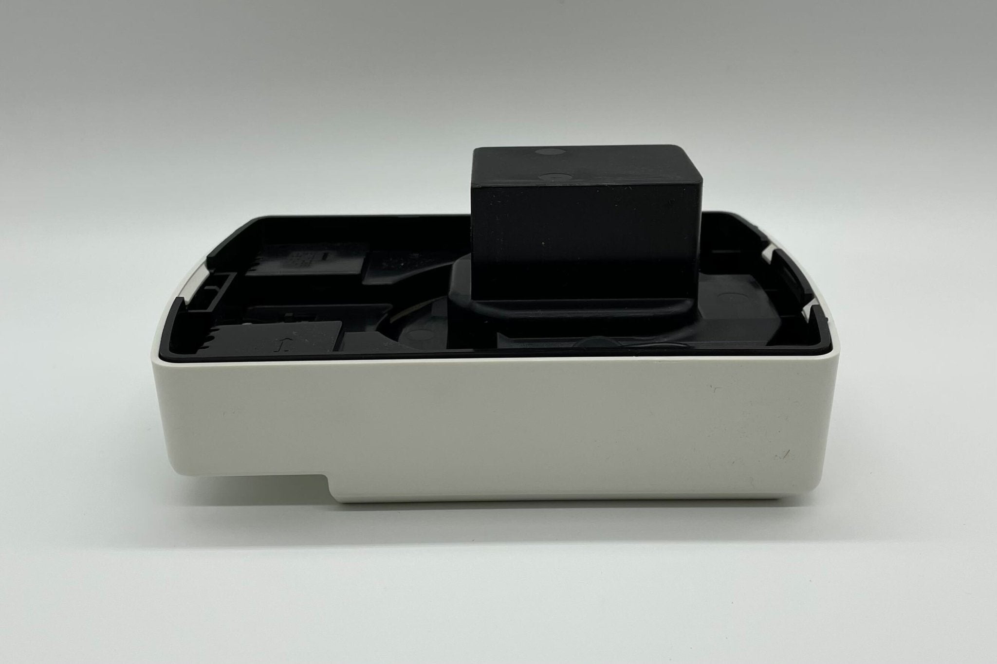 Eaton Wheelock ELFHNW-N horn strobe alarm device mounted on a wall with visible wiring and mounting hardware.