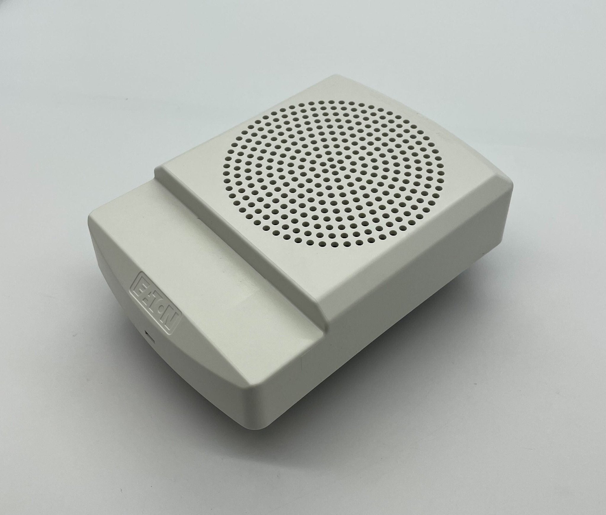 Eaton Wheelock ELFHNW-N horn strobe alarm with white housing and mounting hardware, designed for visual and auditory alerting systems.