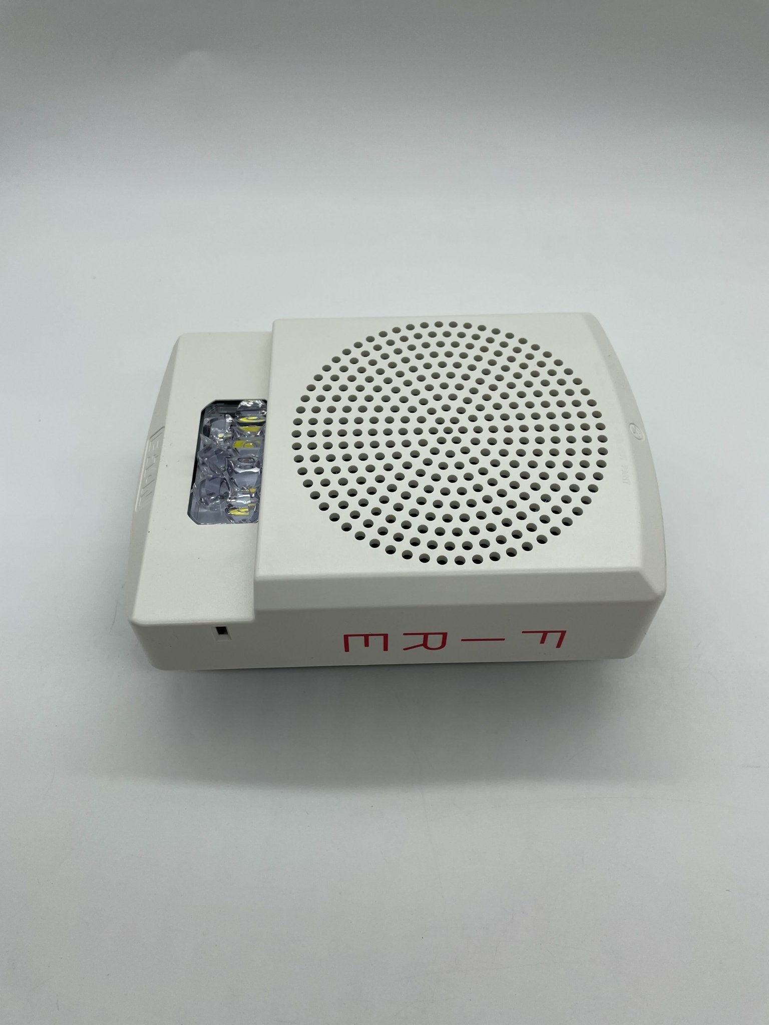 Eaton Wheelock ELFHSW horn strobe alarm device with white housing and mounting bracket, designed for fire alarm systems.