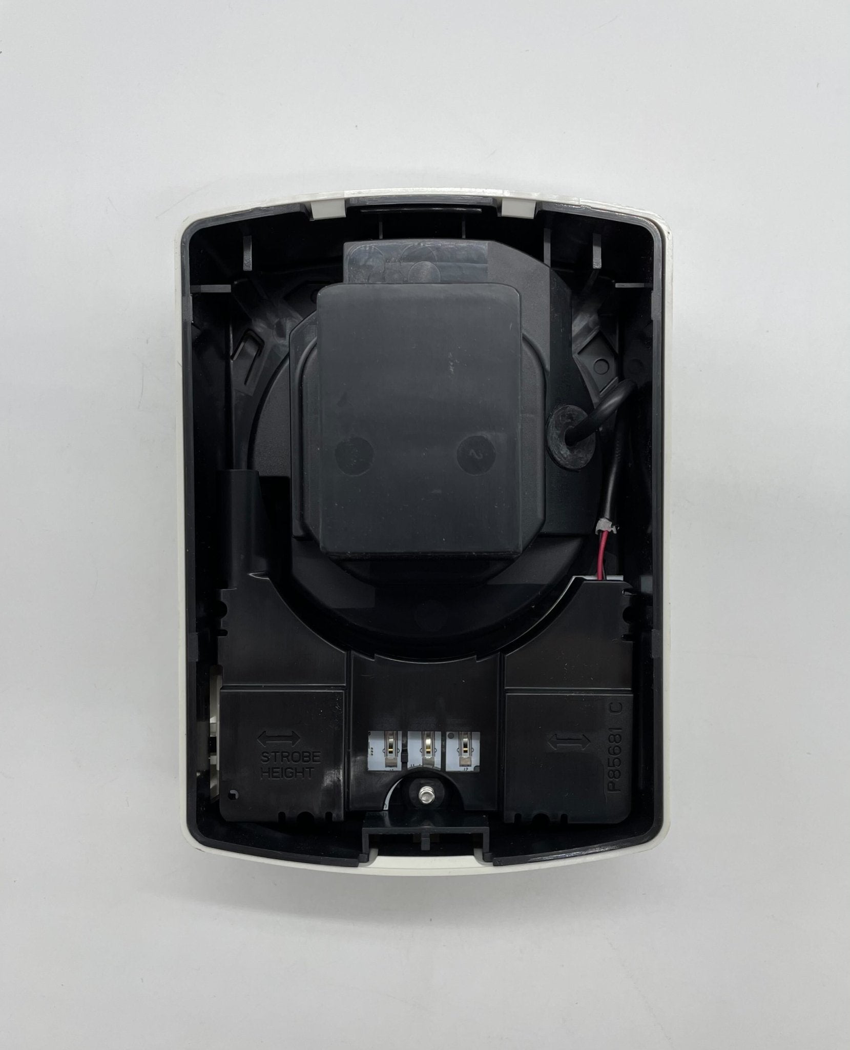 Eaton Wheelock ELFHSW horn strobe alarm device with white housing and visible wiring for fire safety systems.