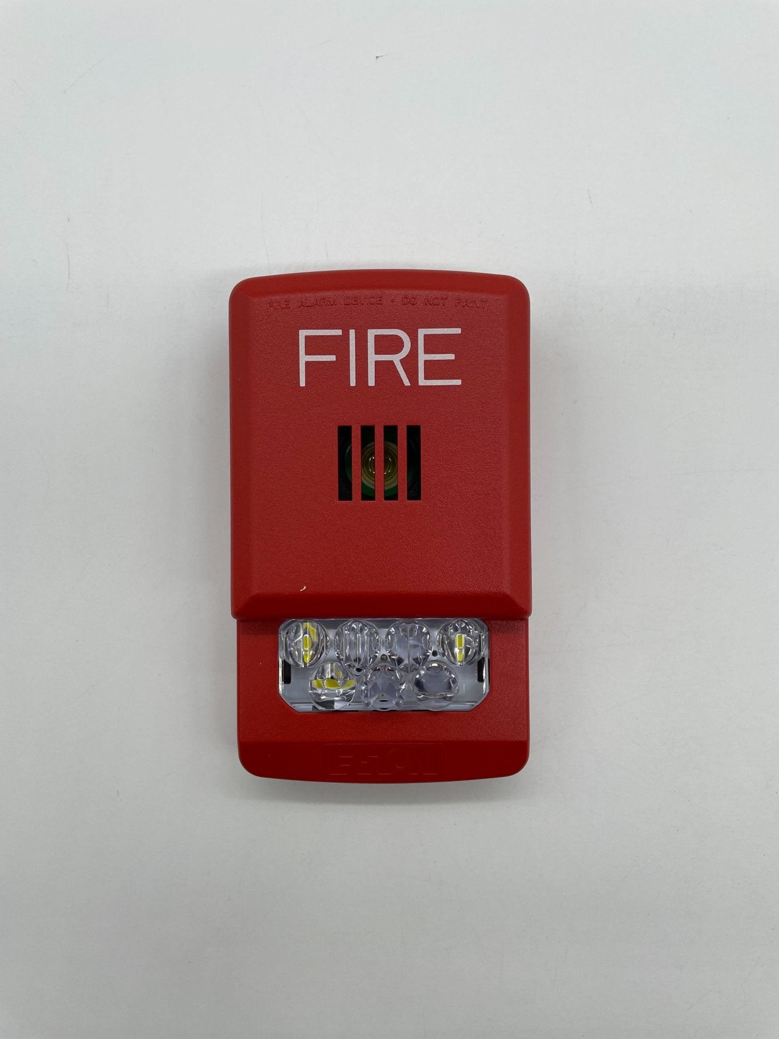 Eaton Wheelock ELHSR horn strobe with red housing and mounting hardware for emergency alert systems.