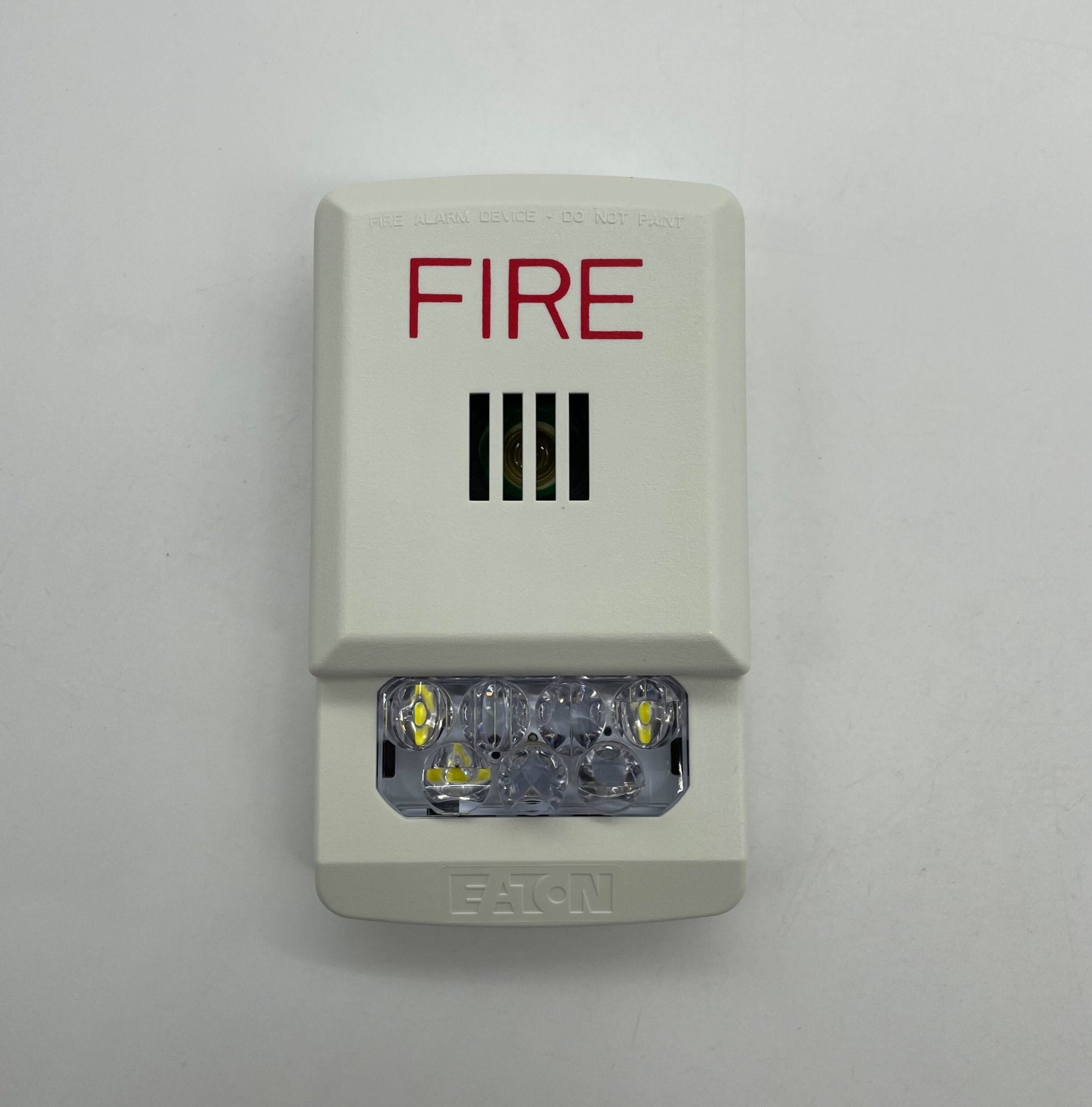Eaton Wheelock ELHSW horn strobe with yellow housing and mounting bracket for fire alarm signaling systems.