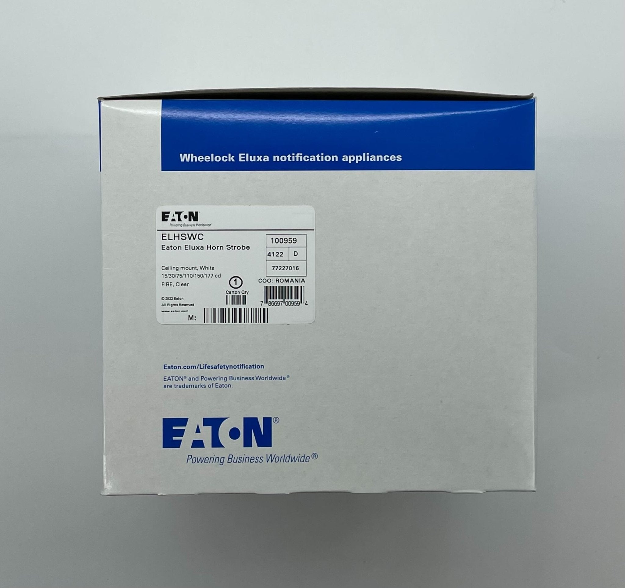 Eaton Wheelock ELHSWC horn strobe alarm with red horn and clear strobe light, mounted on a wall.