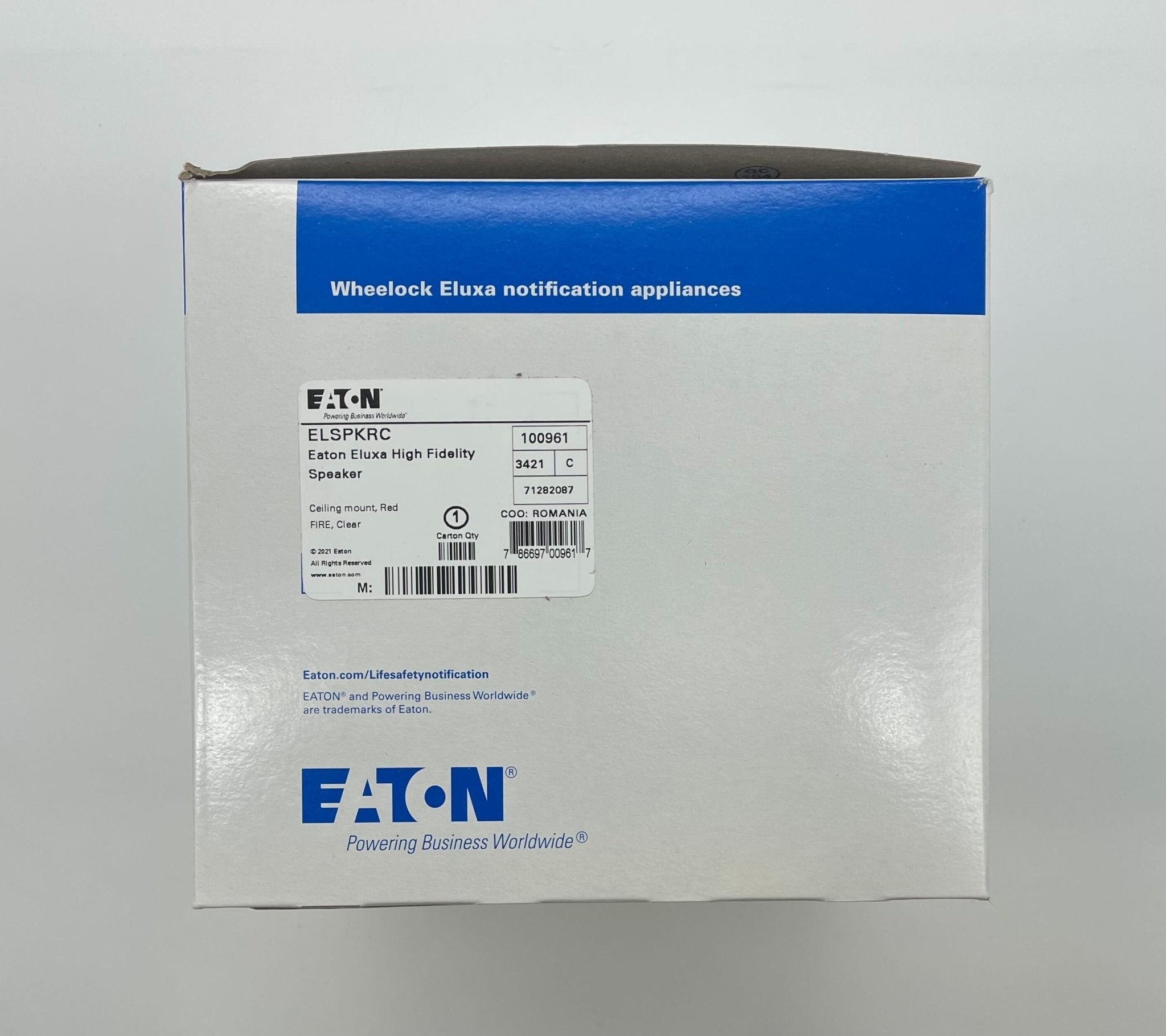 Eaton Wheelock ELSPKRC speaker, black rectangular enclosure with mounting brackets, designed for commercial audio systems