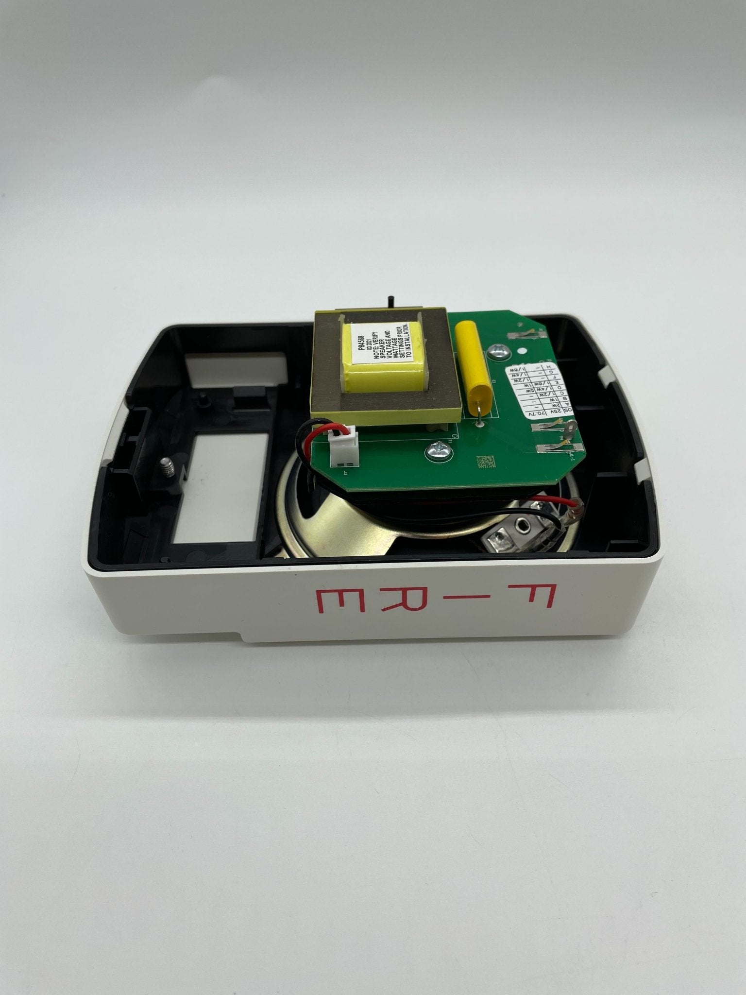 Eaton Wheelock ELSPKW emergency strobe light with mounting bracket, visible in a black housing with wiring connections