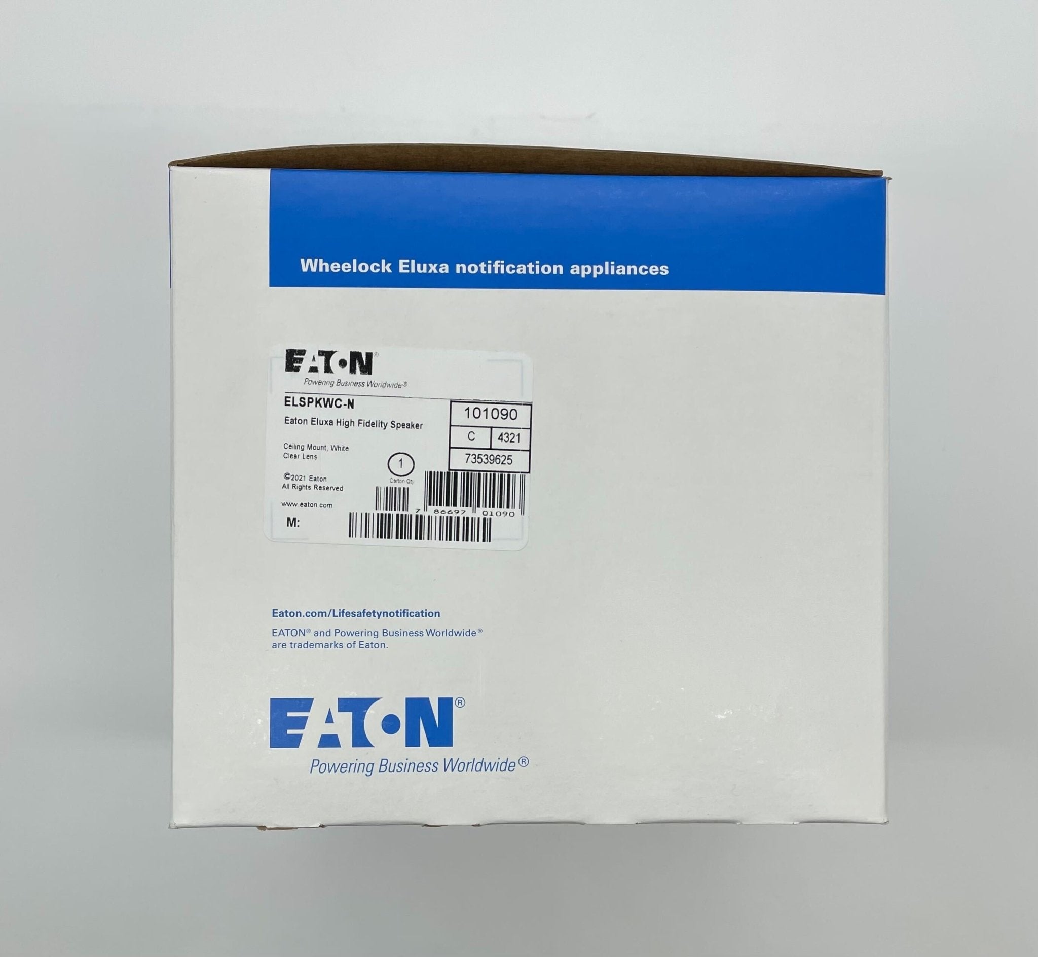 Eaton Wheelock ELSPKWC-N speaker with black enclosure, mounted on wall, designed for commercial sound applications