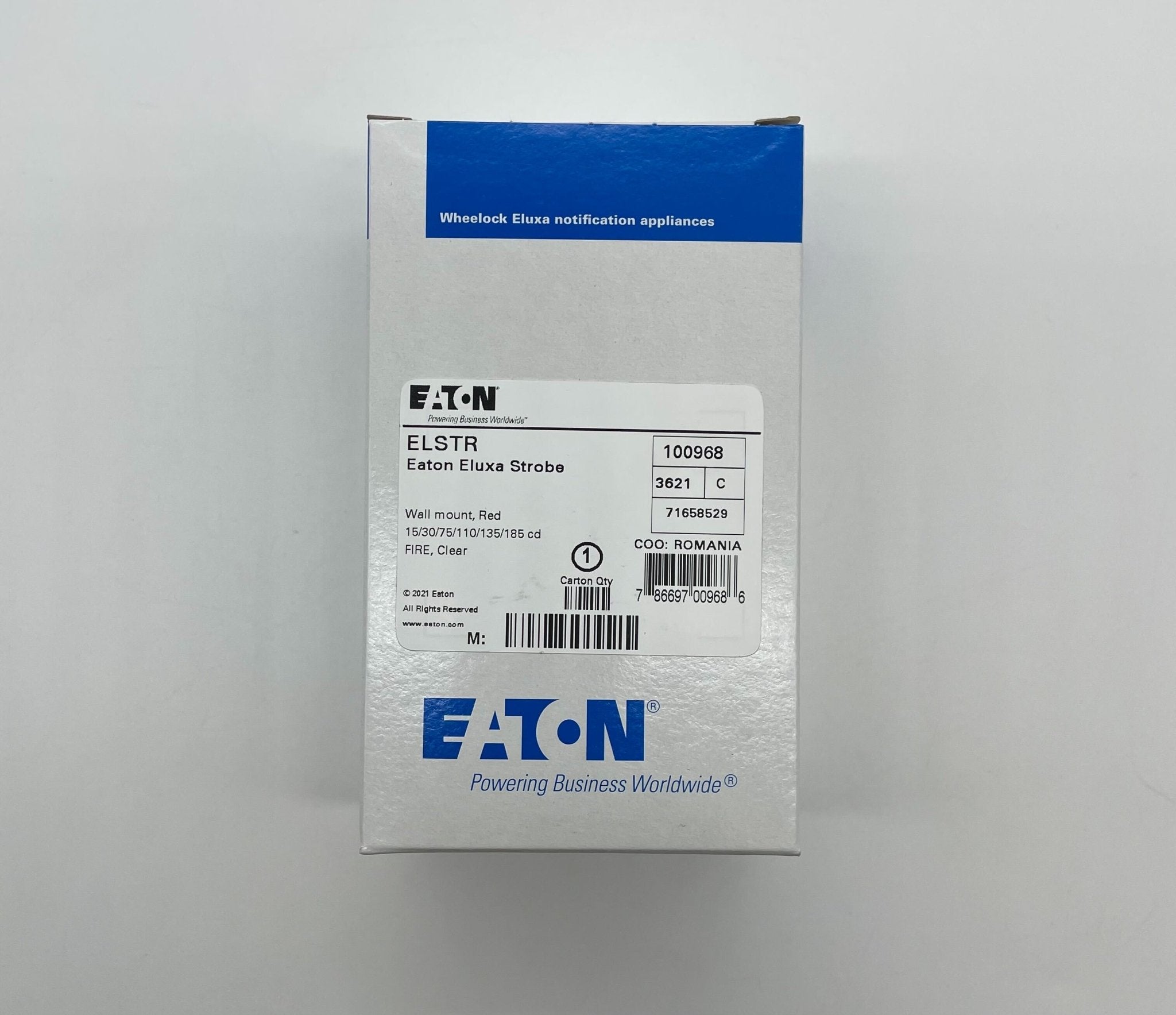 Eaton Wheelock ELSTR strobe light fixture with clear lens and mounting hardware, designed for emergency signaling and safety.