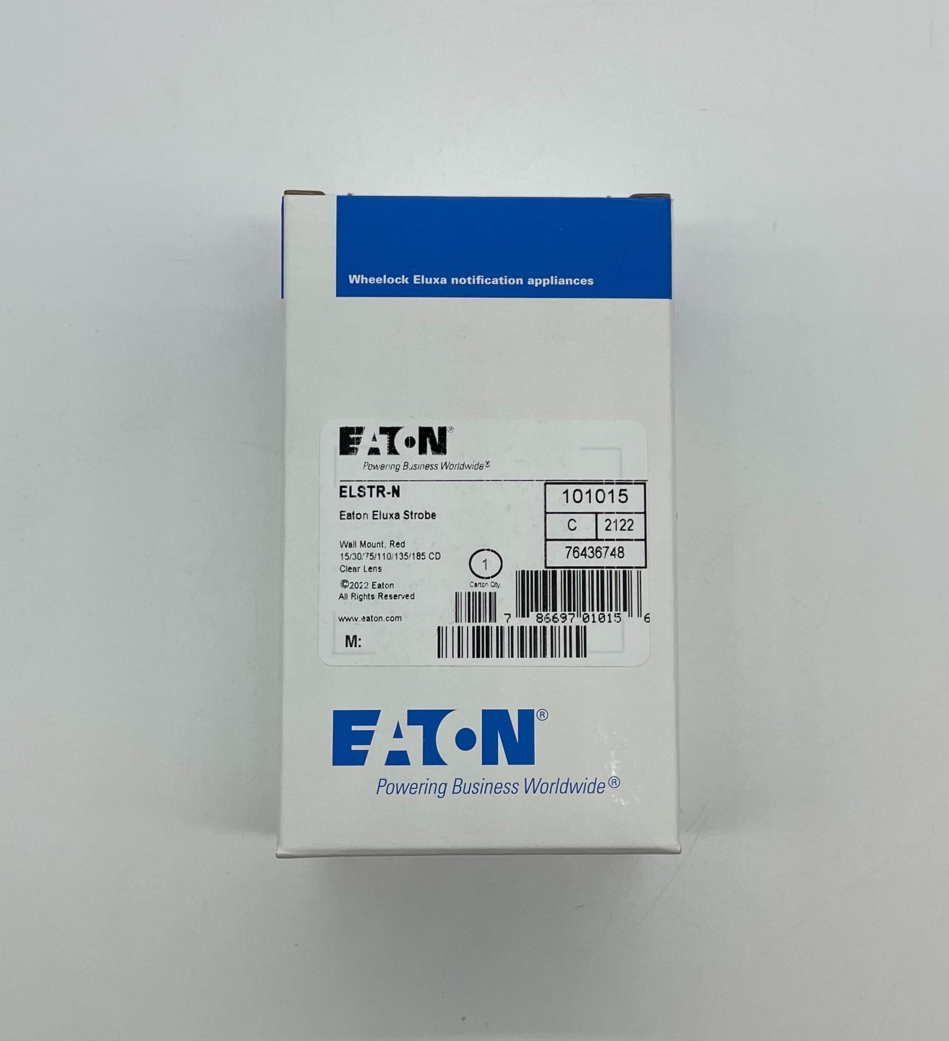 Eaton Wheelock ELSTR-N strobe light mounted on ceiling, clear lens, part of emergency signaling system.