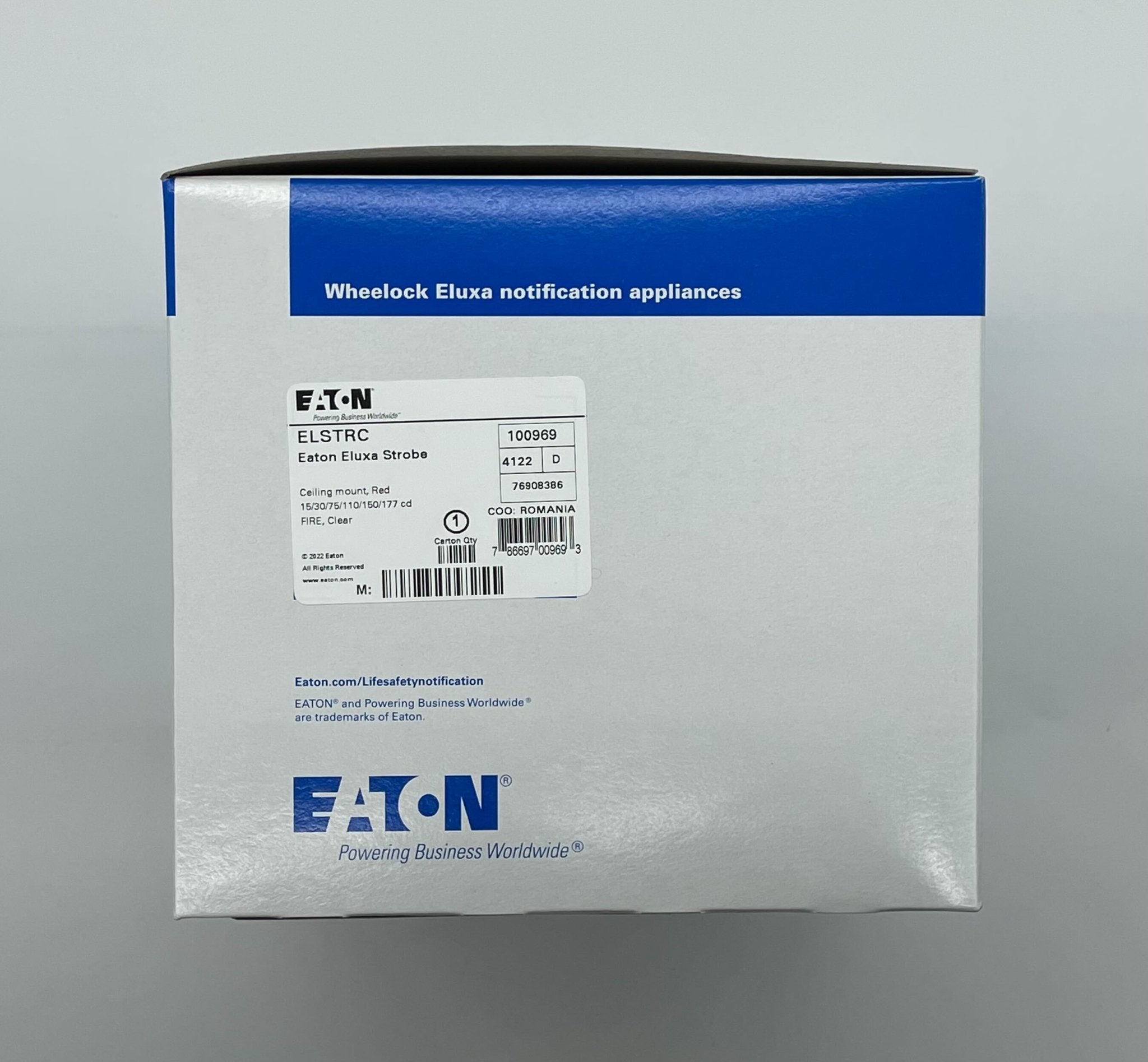 Eaton Wheelock ELSTRC strobe light fixture with clear lens and mounting bracket, designed for emergency signaling.