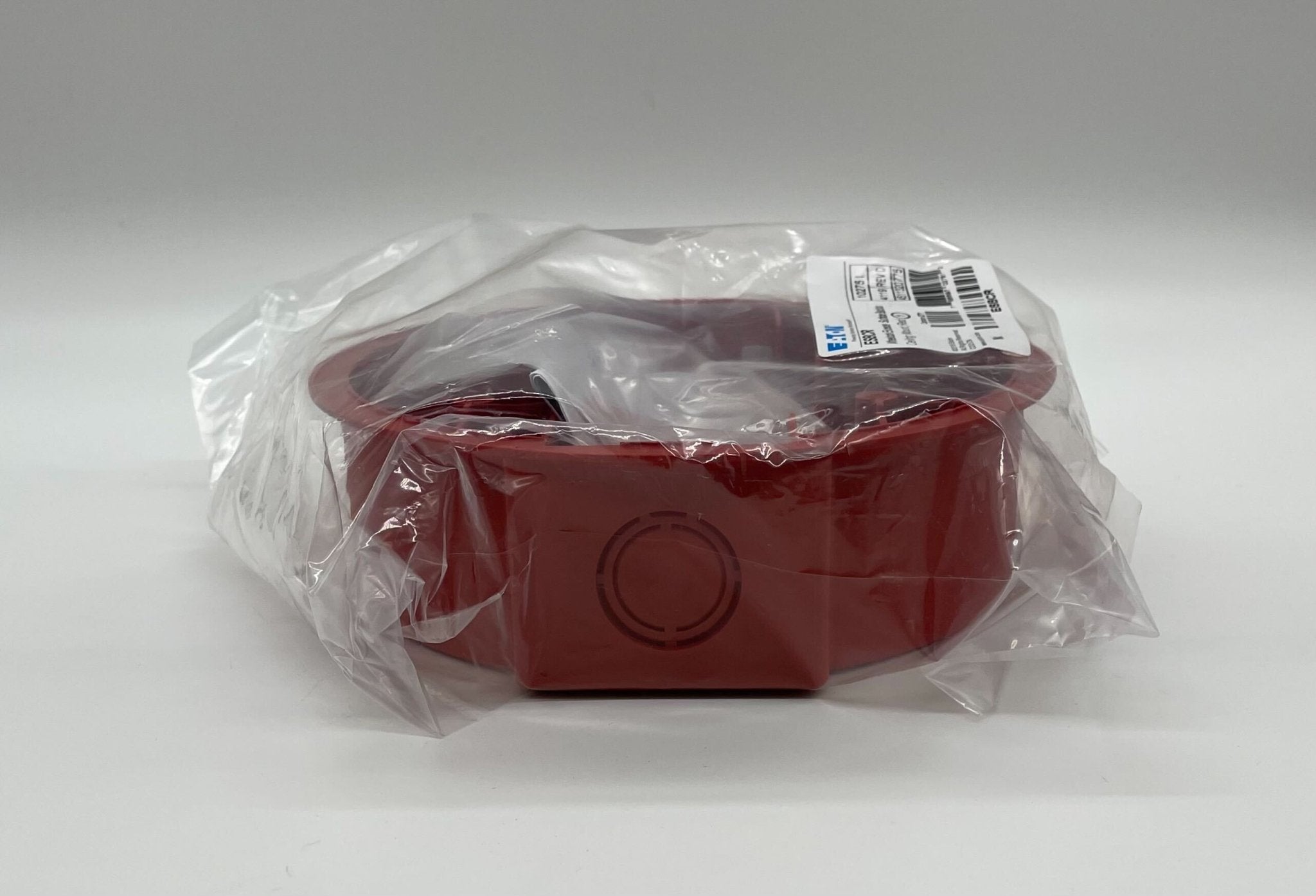 Eaton Wheelock ESBCR fire alarm with black enclosure and control panel, mounted on wall, for fire safety systems.
