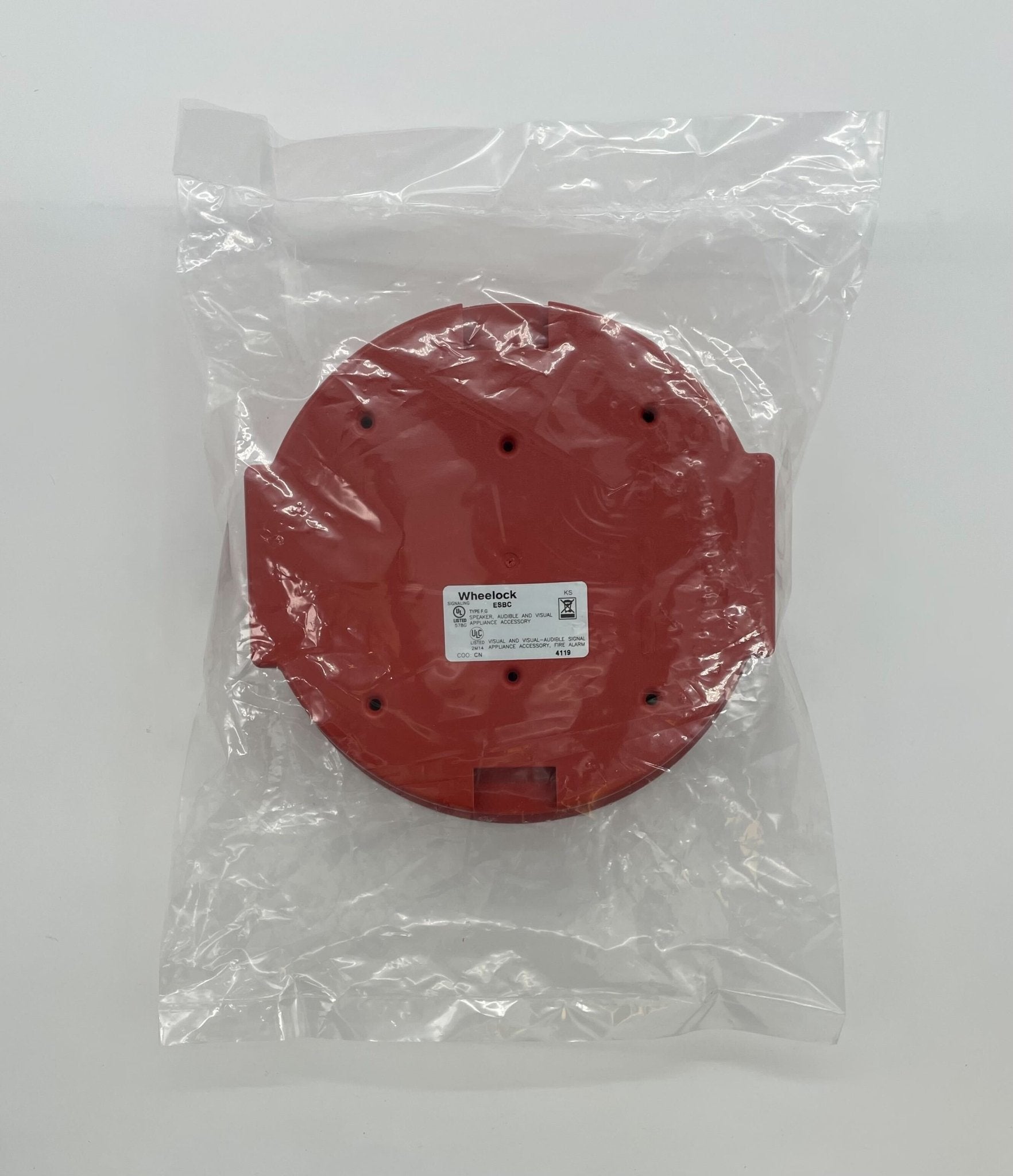 Eaton Wheelock ESBCR fire alarm with test switch and indicator light, mounted on a wall for fire safety detection.