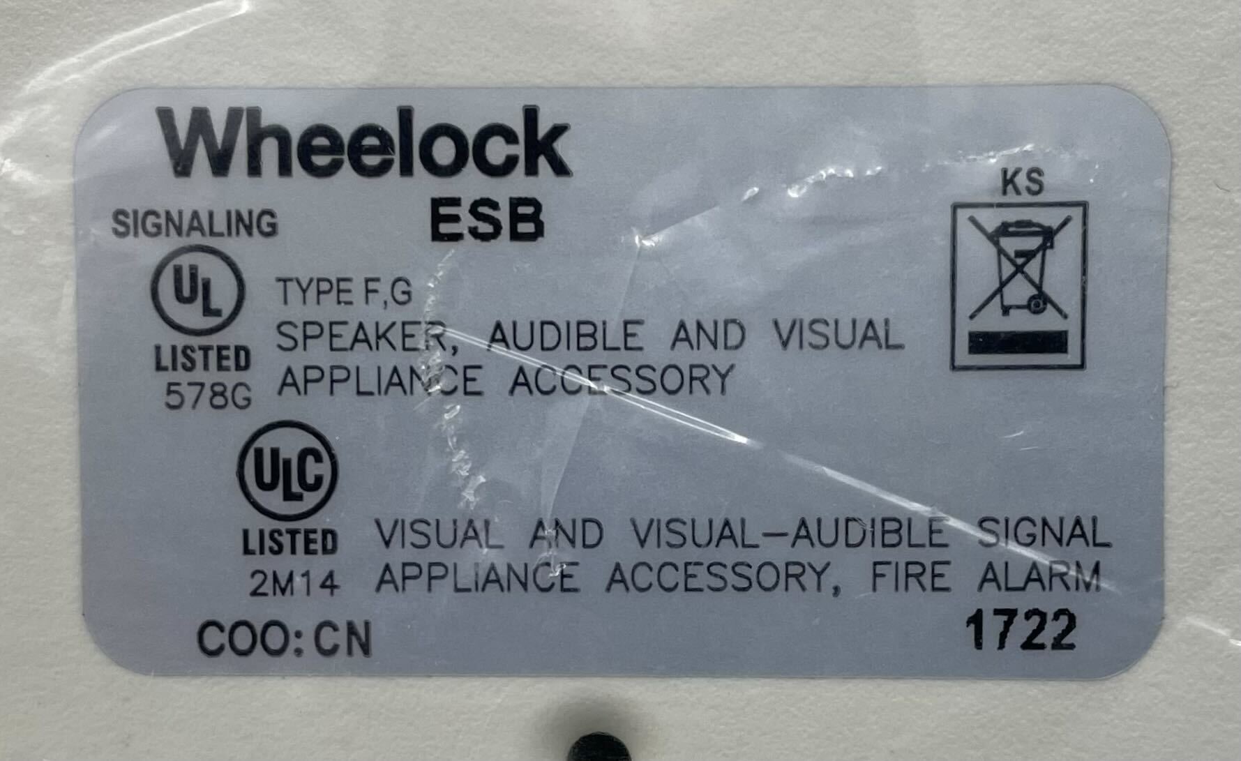 Eaton Wheelock ESBW fire alarm with horn strobe, mounted on wall, designed for emergency alert signaling.