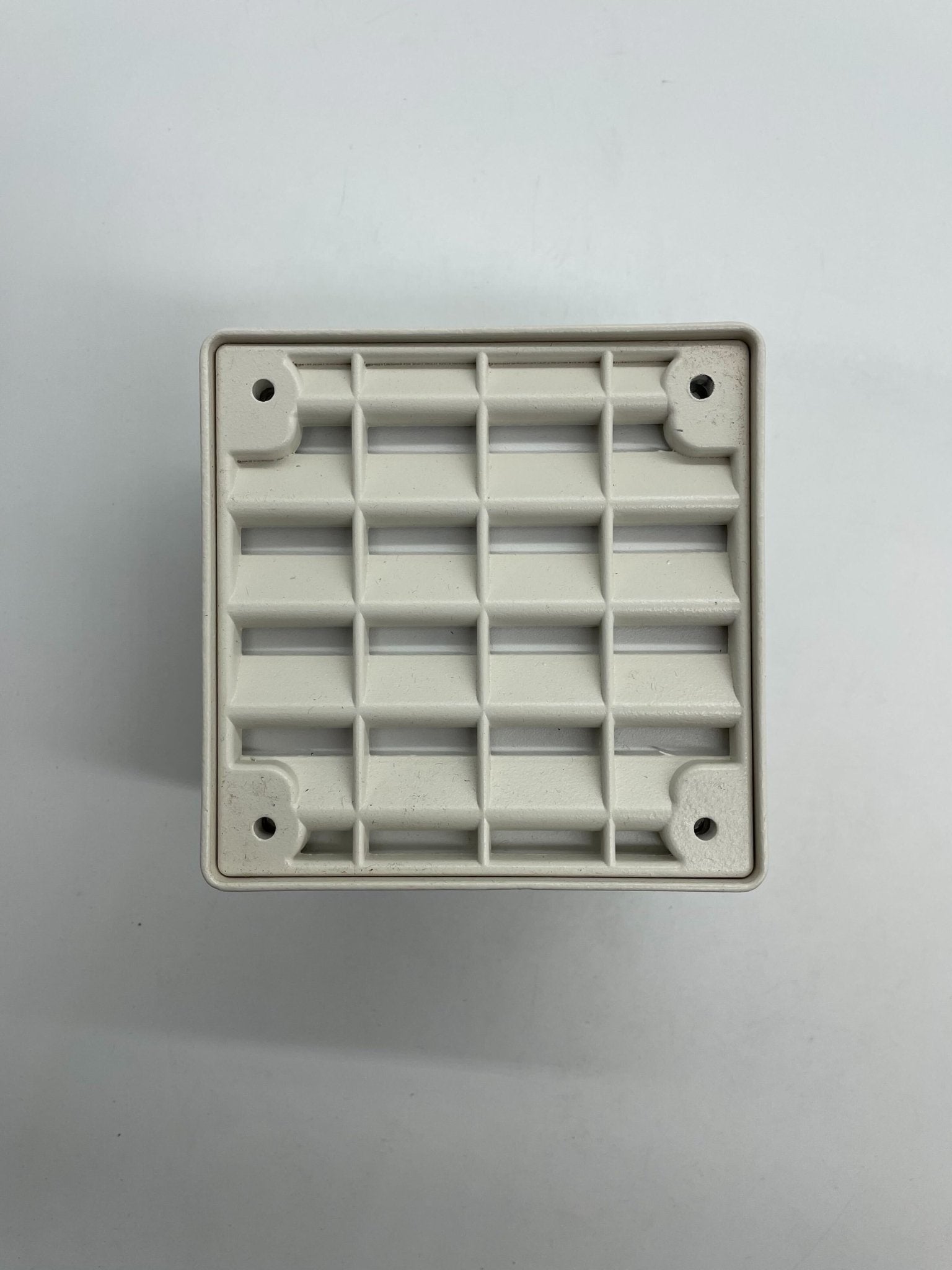 Eaton Wheelock ET-1010-W speaker mounted on wall, black audio device with brand logo visible.