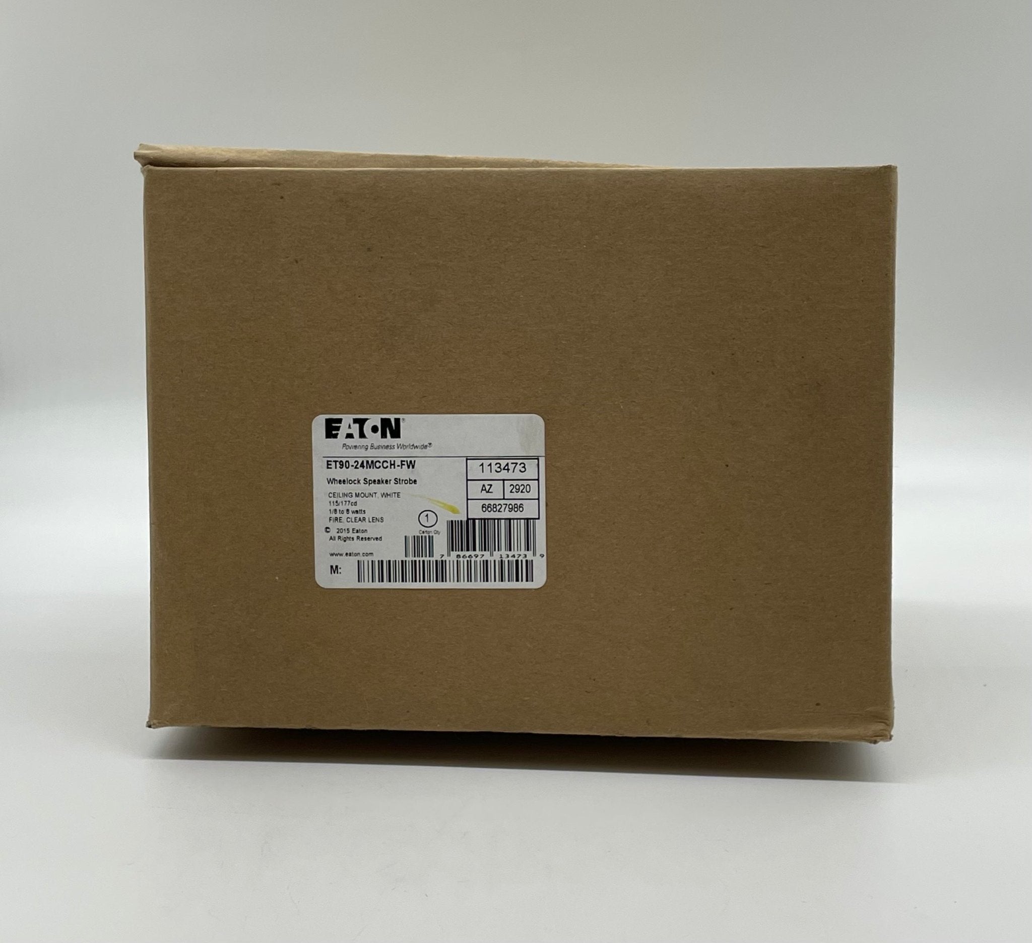 Eaton Wheelock ET90-24MCCH-FW speaker strobe with a red housing and mounting bracket, designed for fire alarm notification systems.