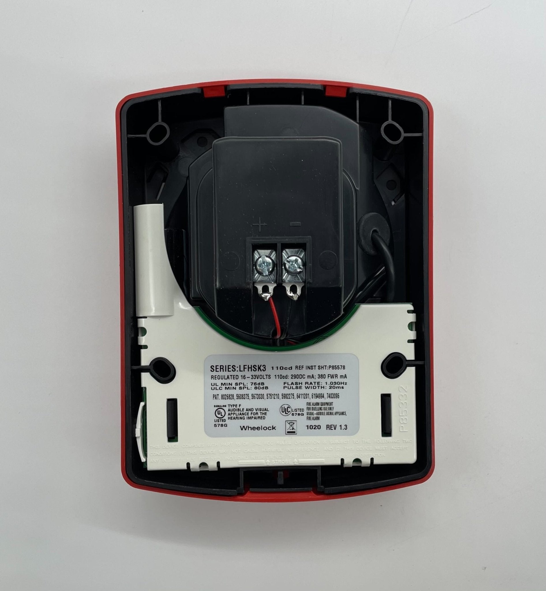 Eaton Wheelock LFHSKR3 Horn Strobe with red housing and clear cover, mounted on a ceiling for emergency alert signaling