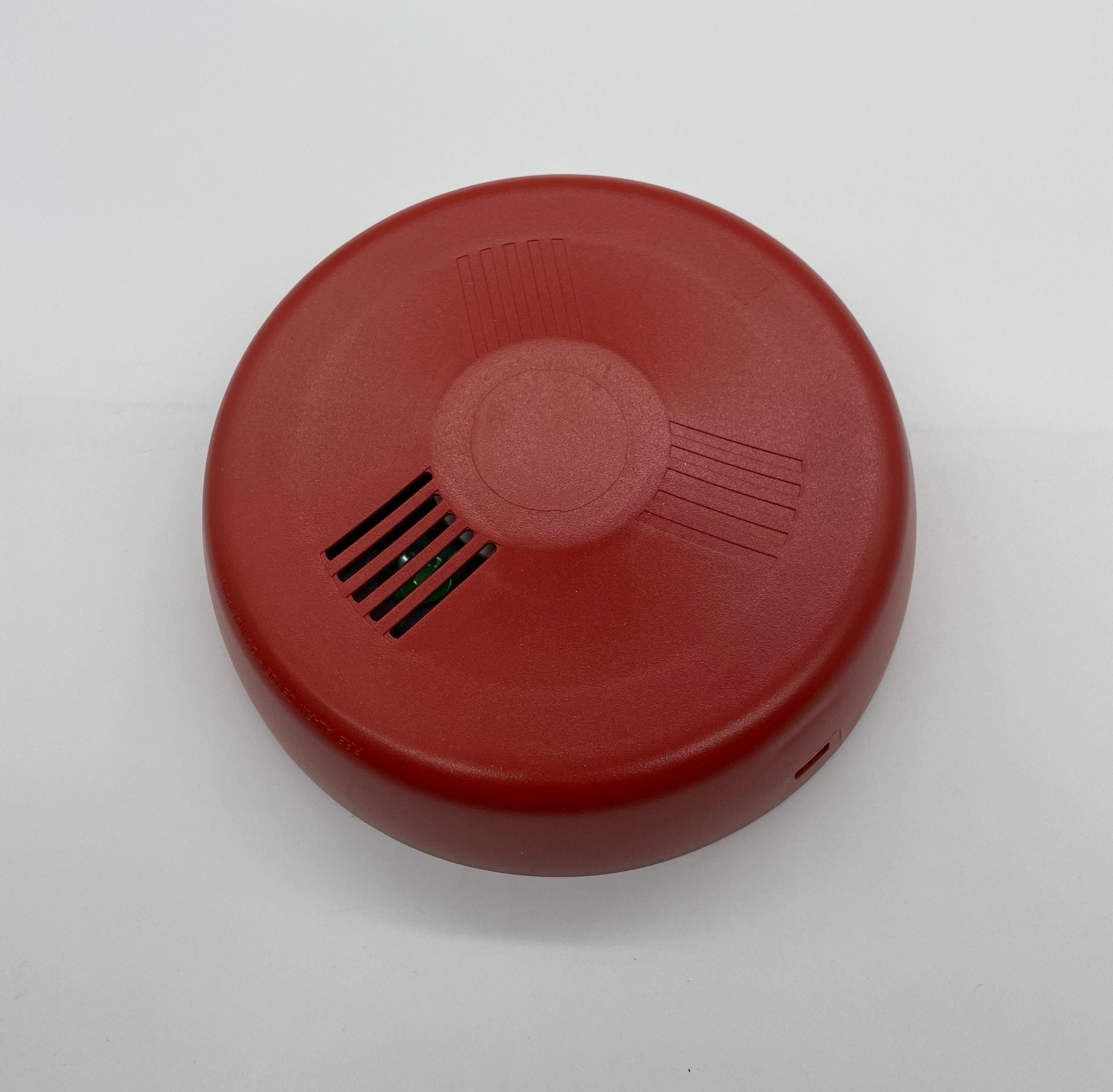Eaton Wheelock LHNRC3 fire alarm with red and white detection device mounted on wall, part of Eaton Wheelock fire alarm system