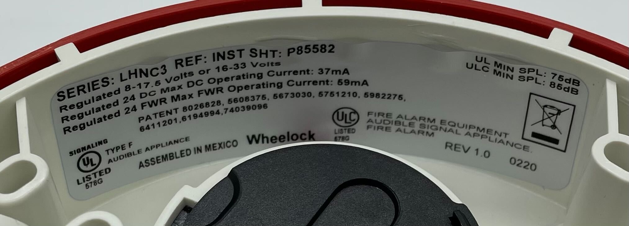 Eaton Wheelock LHNRC3 fire alarm horn/strobe with red housing and mounting bracket, designed for fire safety systems.