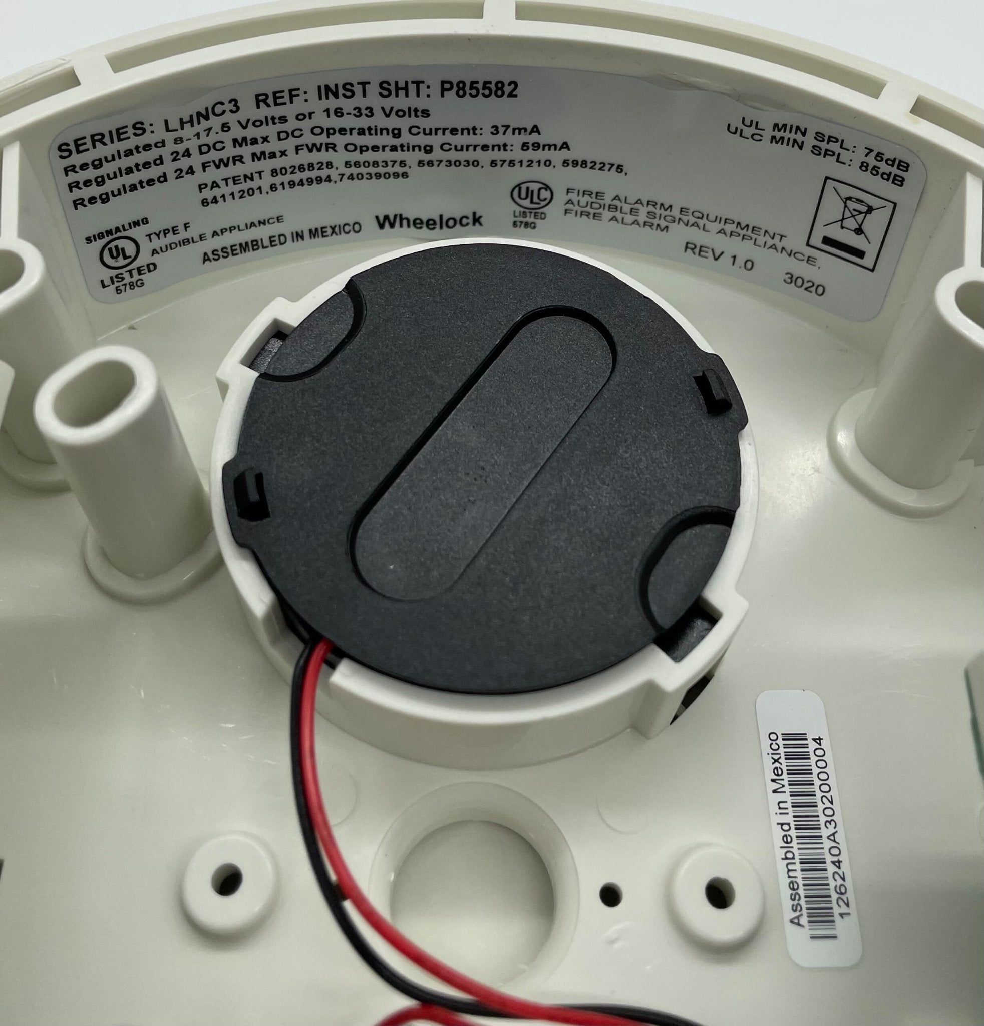 Eaton Wheelock LHNWC3 fire alarm sounder with white casing and mounting bracket, designed for emergency alert systems.