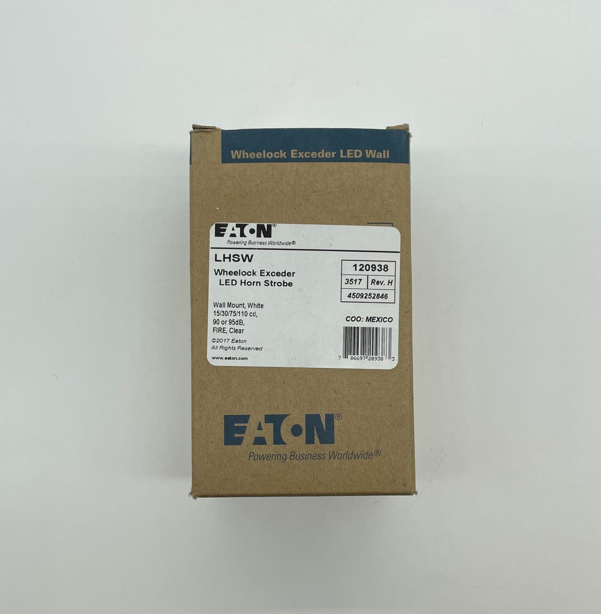 Eaton Wheelock LHSW horn strobe alarm device with orange housing and mounting bracket, designed for emergency notification systems.