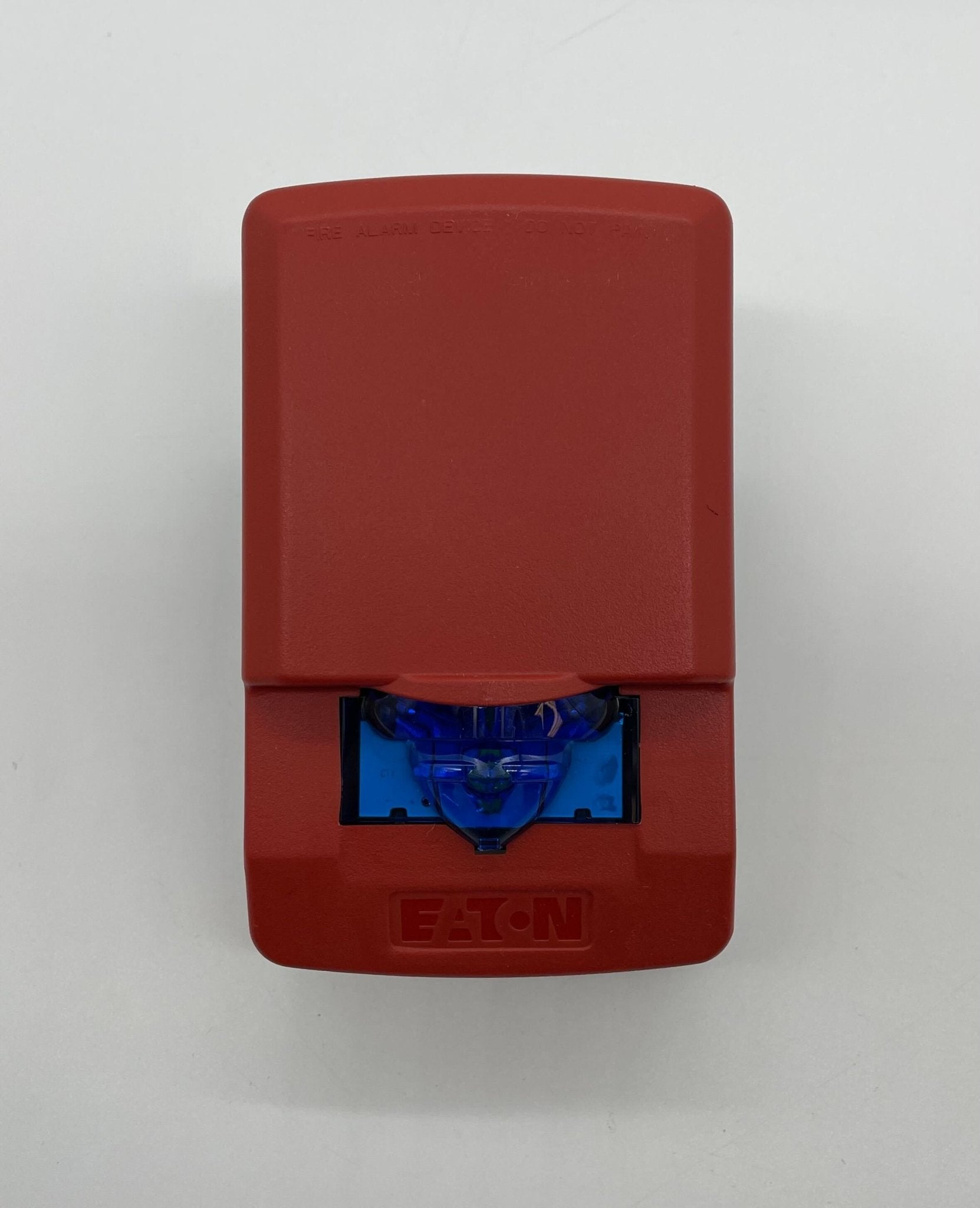 Eaton Wheelock LSTR3-NB strobe light with clear lens and black housing, mounted on a wall for emergency signaling.