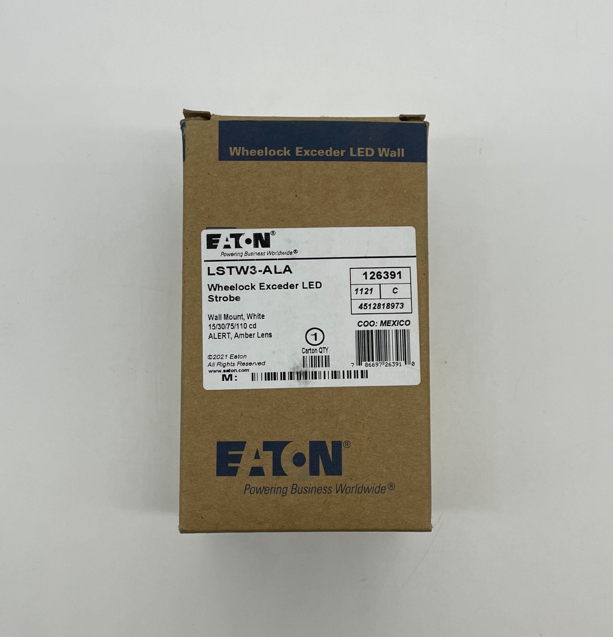 Eaton Wheelock LSTW3-ALA strobe light with clear lens and mounting bracket, designed for emergency signaling and alert systems.
