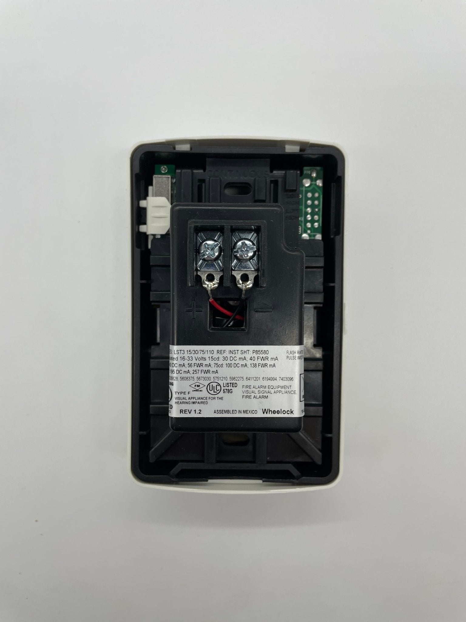 Eaton Wheelock LSTW3 strobe light with clear lens and mounting bracket for emergency signaling and warning applications.